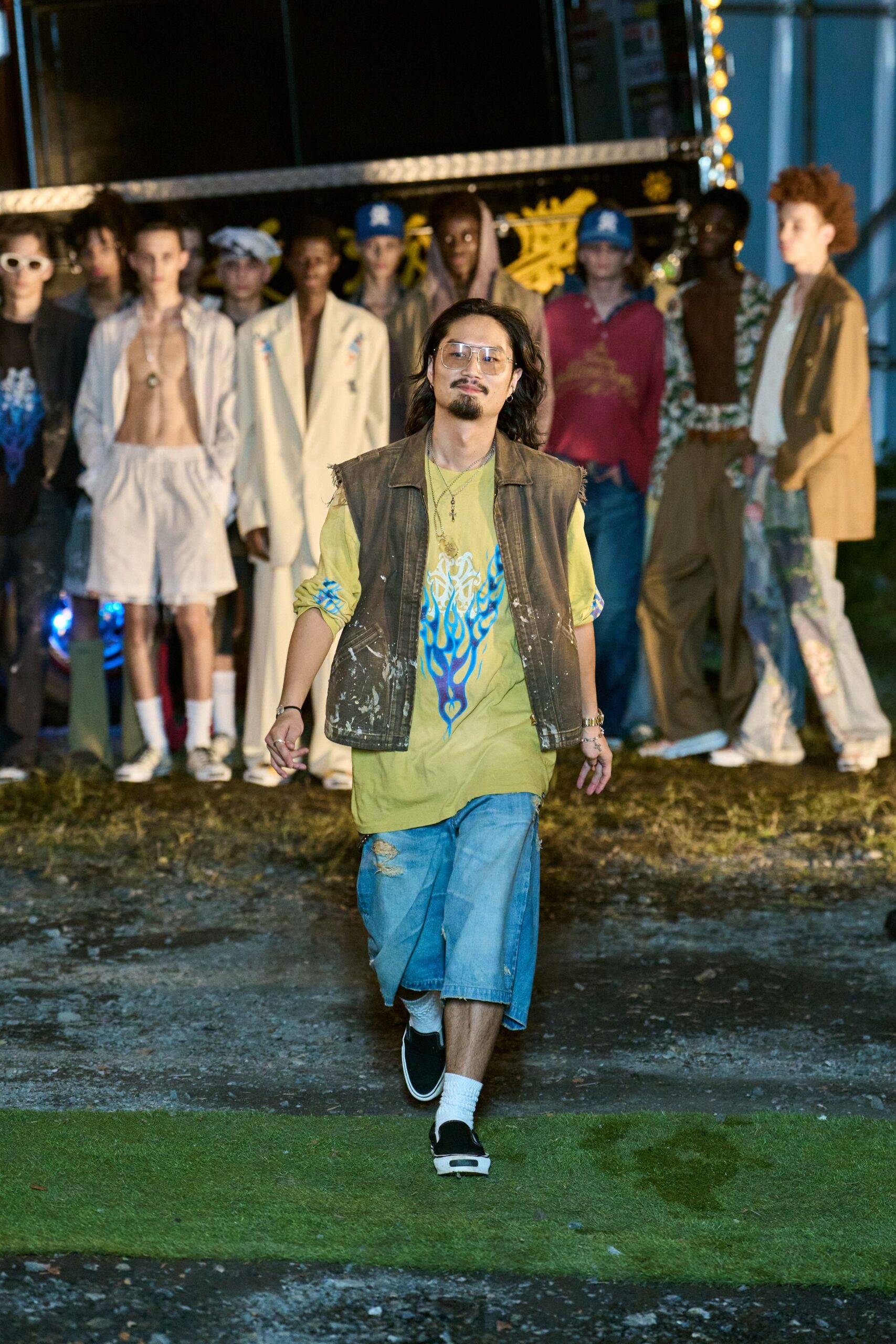 brown vest yellow t-shirt blue shorts
