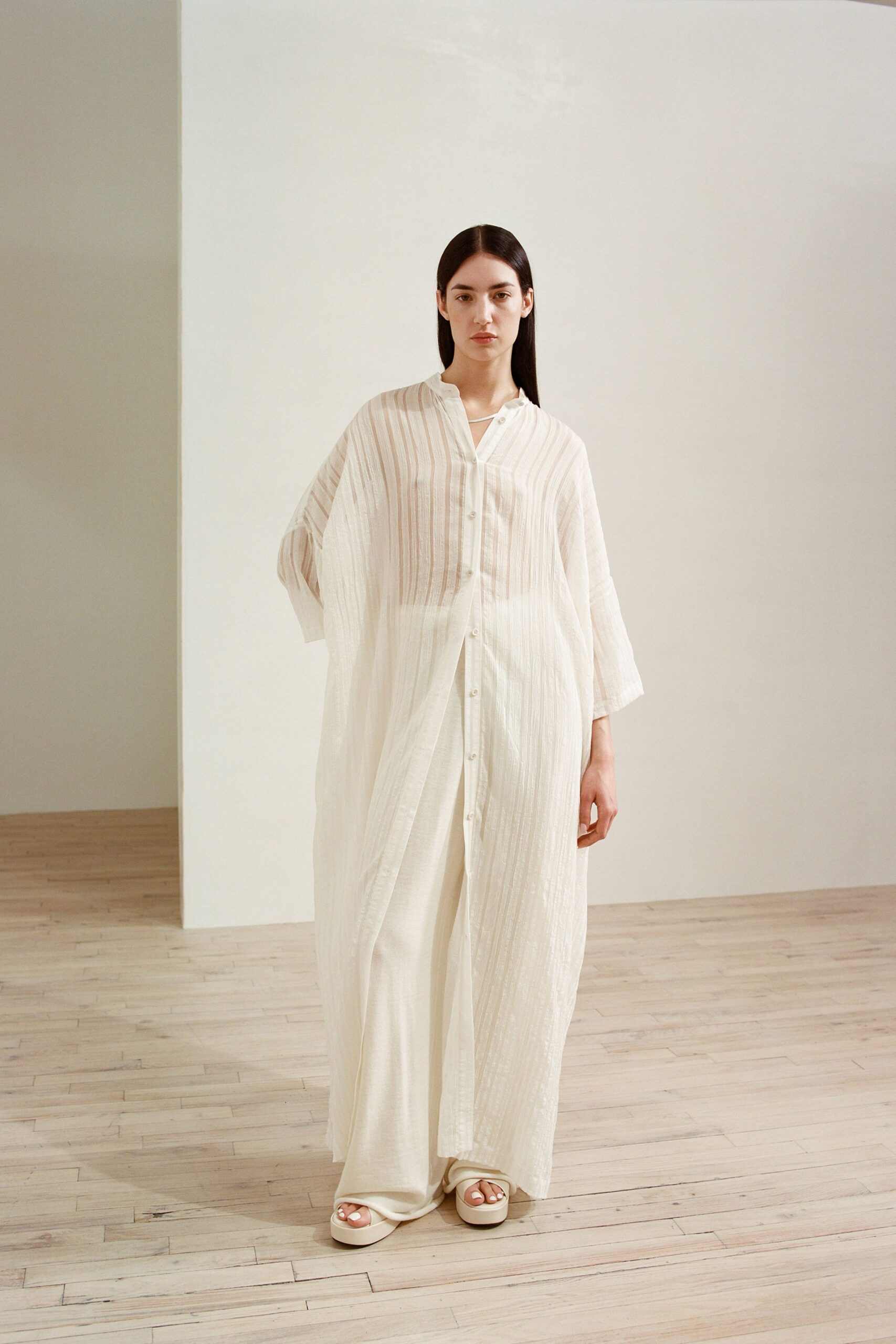 white cotton long-sleeve collared relaxed buttoned pleated dress