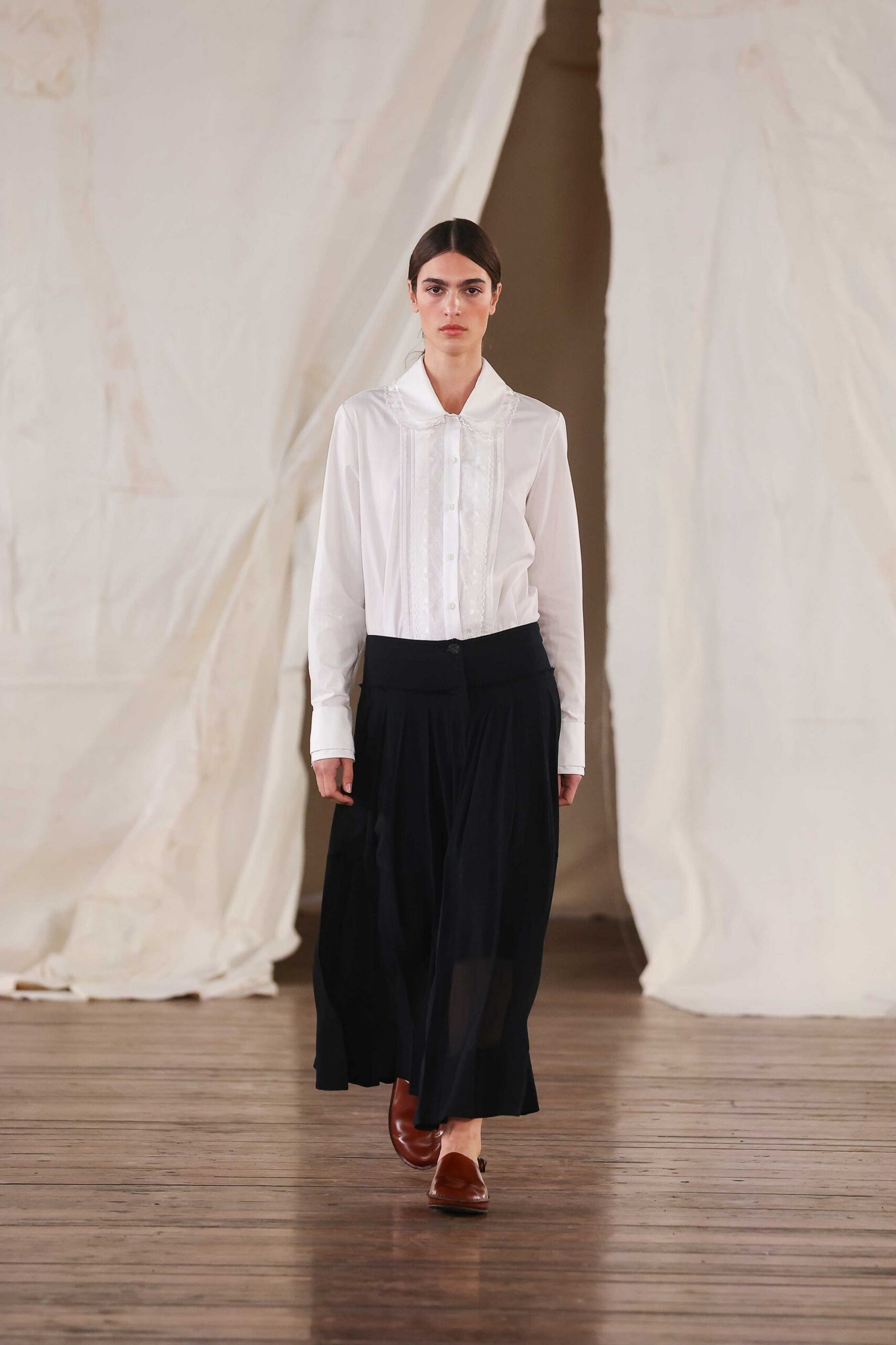 white shirt black pleated skirt