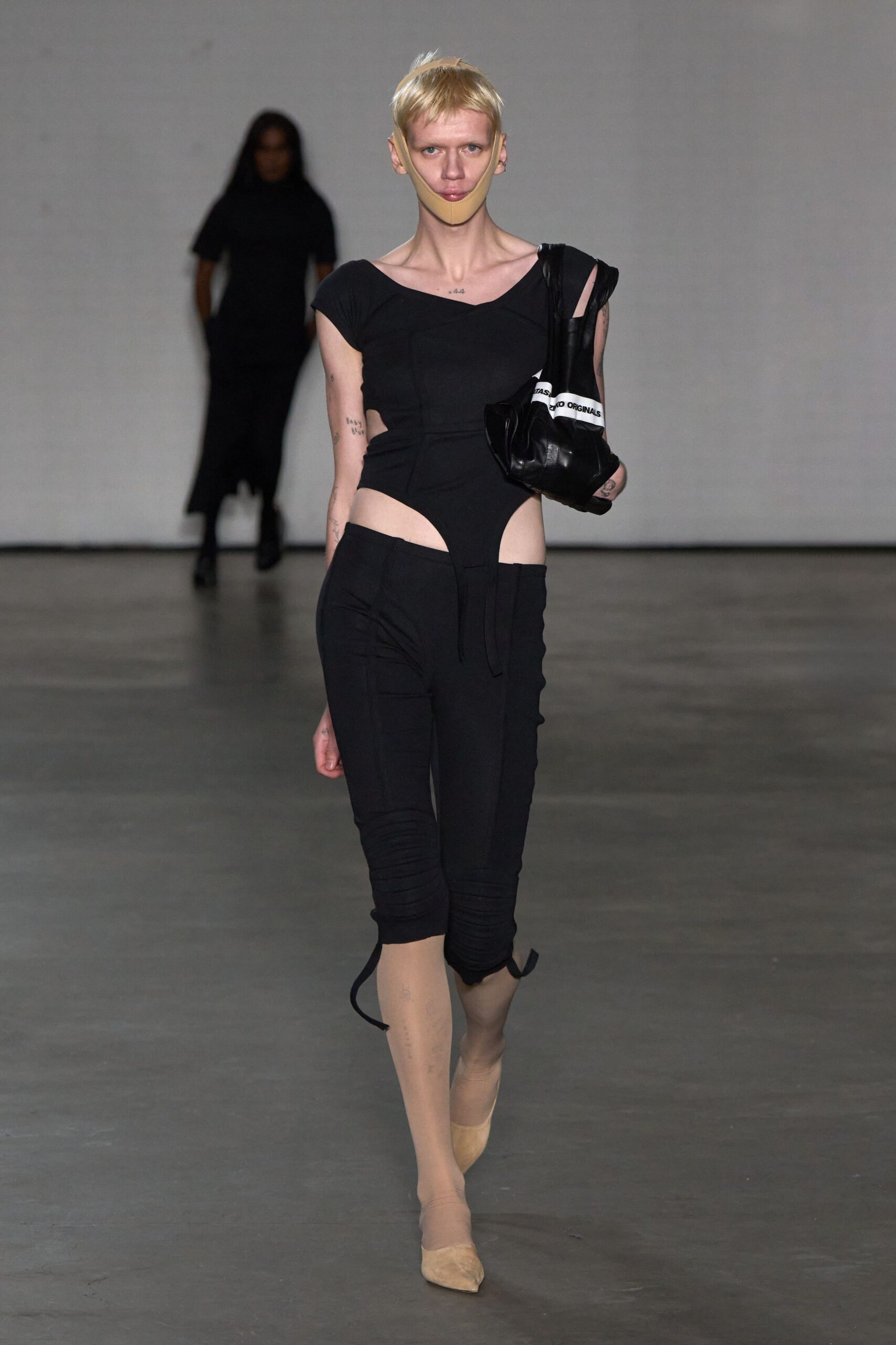 black fitted catsuit with cutouts