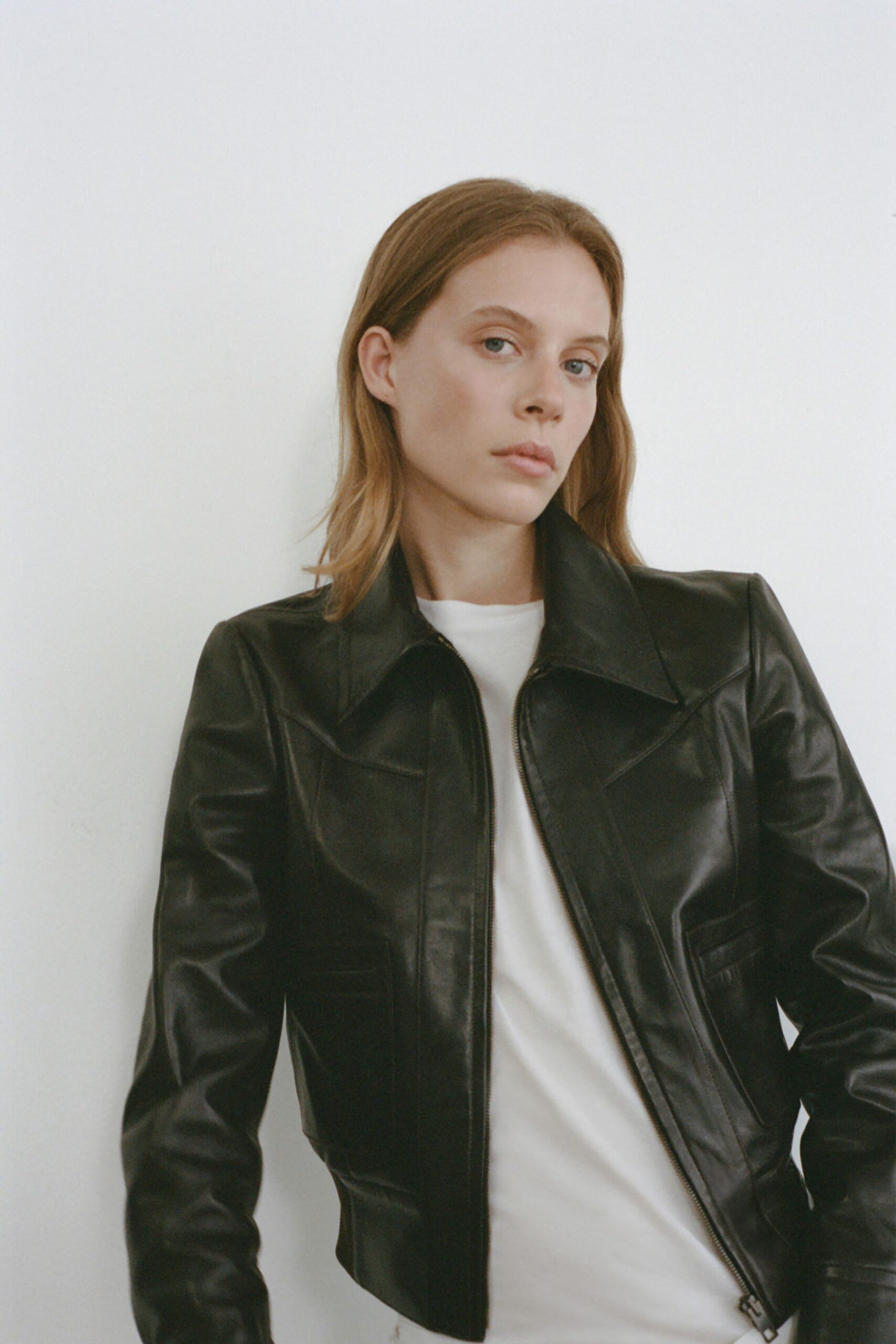 black leather fitted jacket and white t-shirt