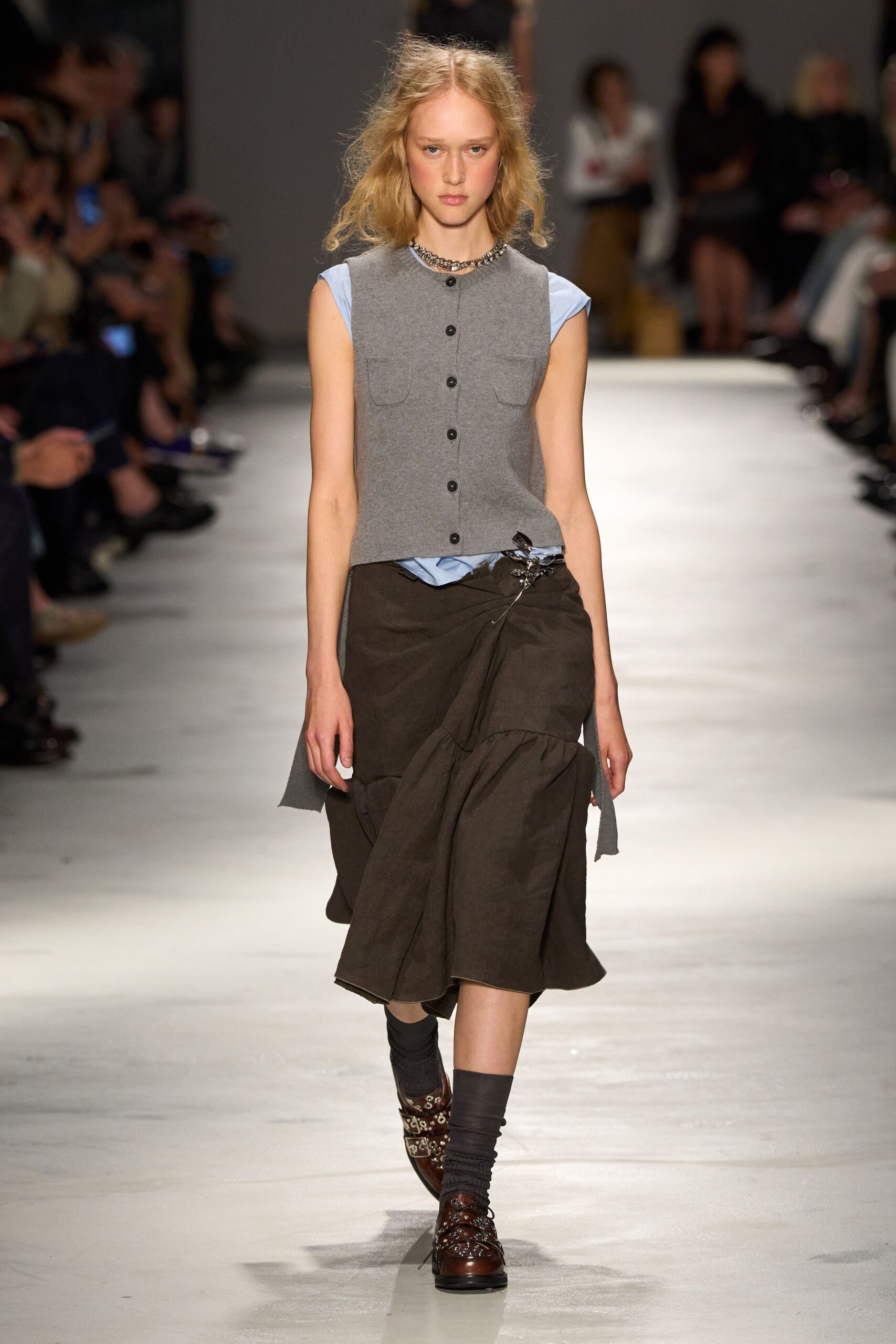 gray vest blue shirt brown skirt