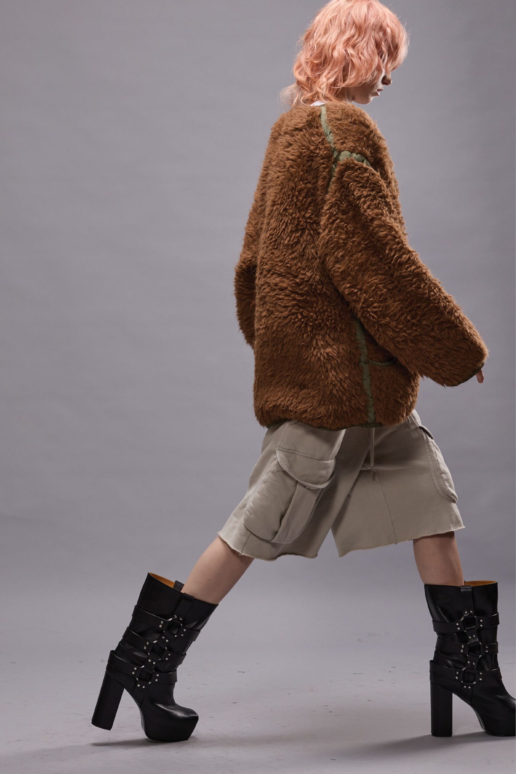 brown faux-fur oversized jacket with beige cargo shorts