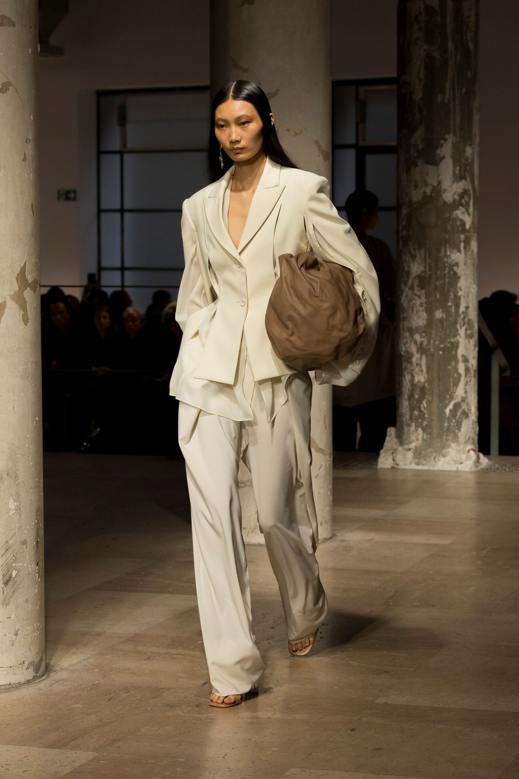white relaxed suit with brown bag