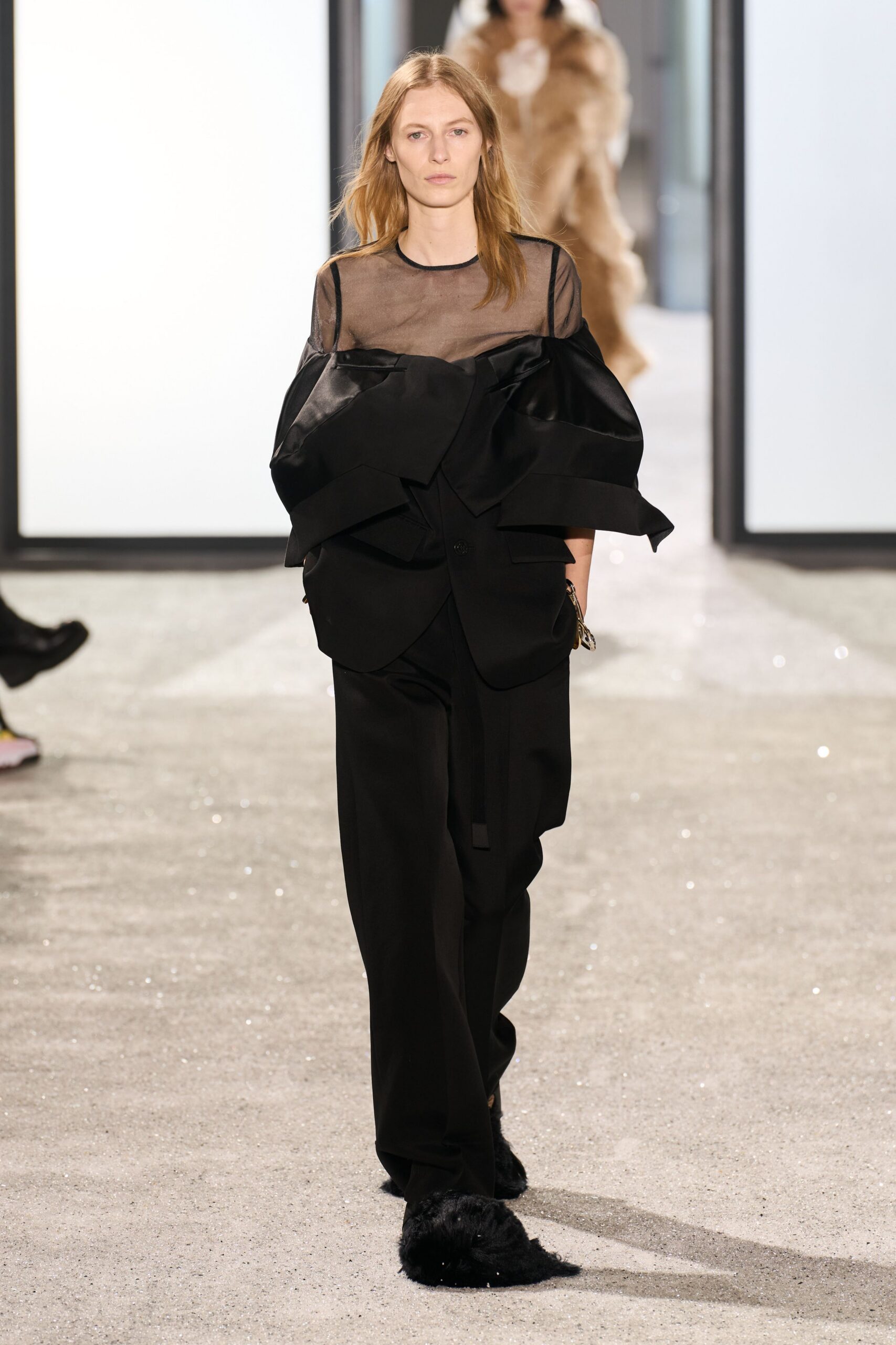 black ruffled blouse with tailored pants
