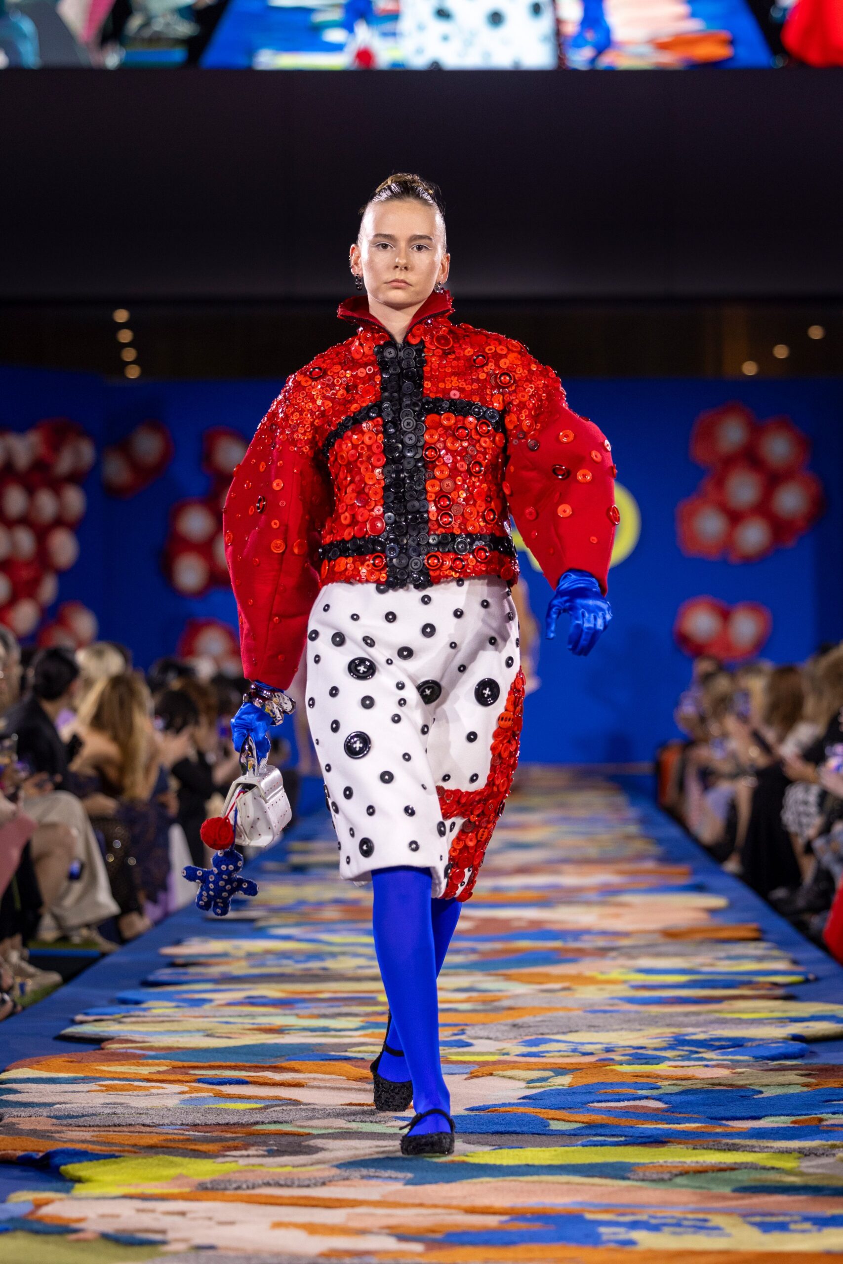 red embroidered jacket with pleated skirt