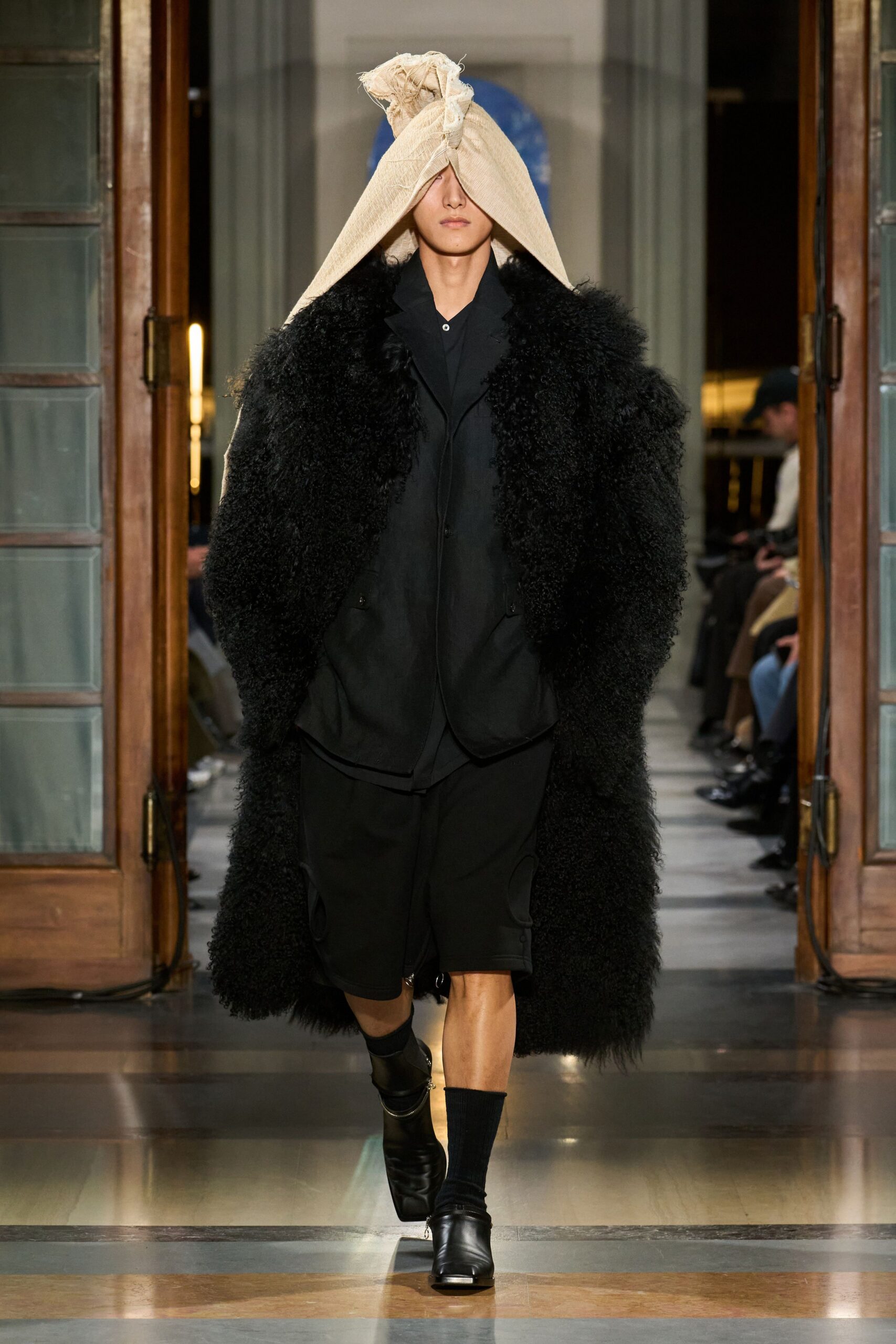 black fur coat with black shirt and shorts