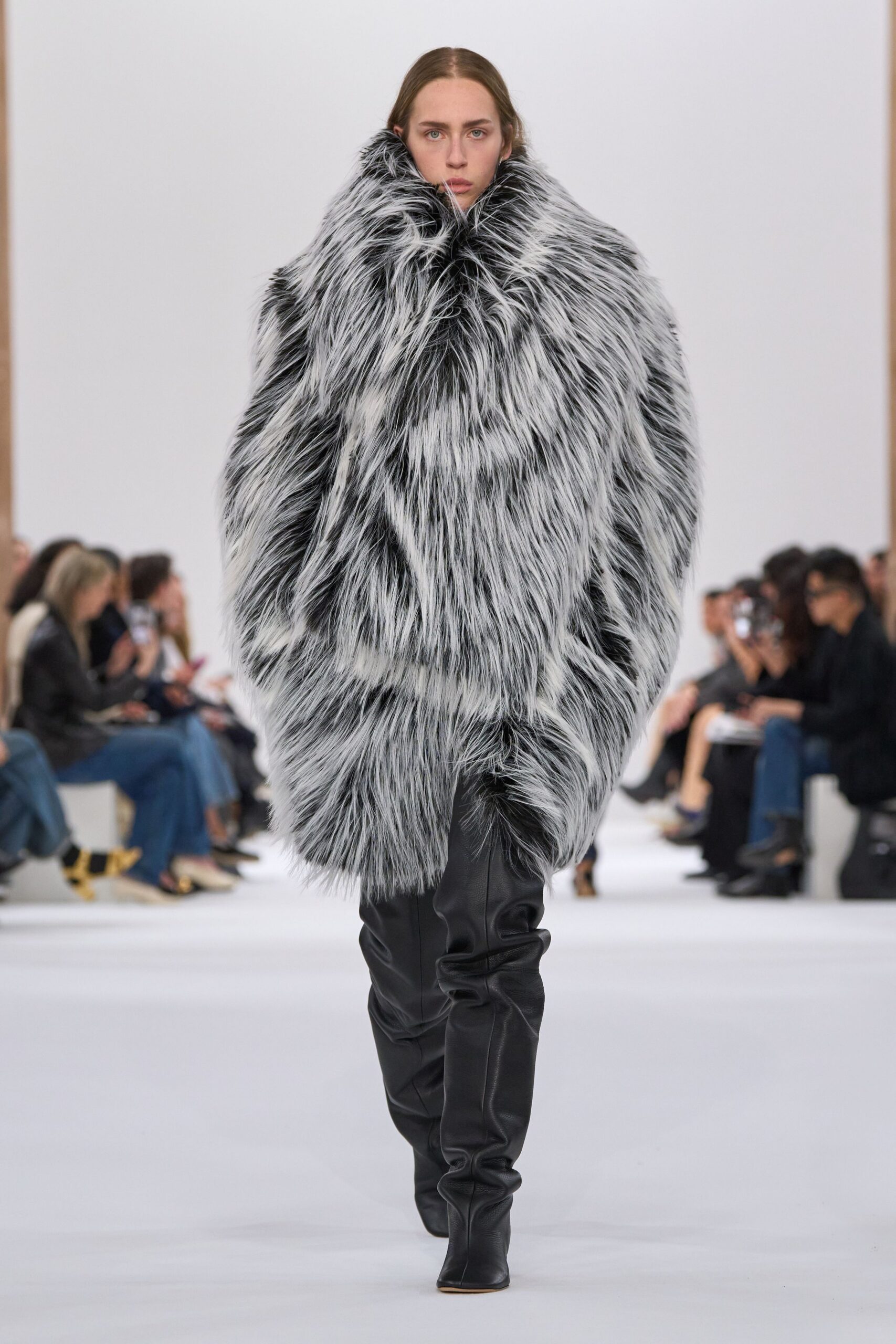 oversized black and white fur coat with fitted black boots