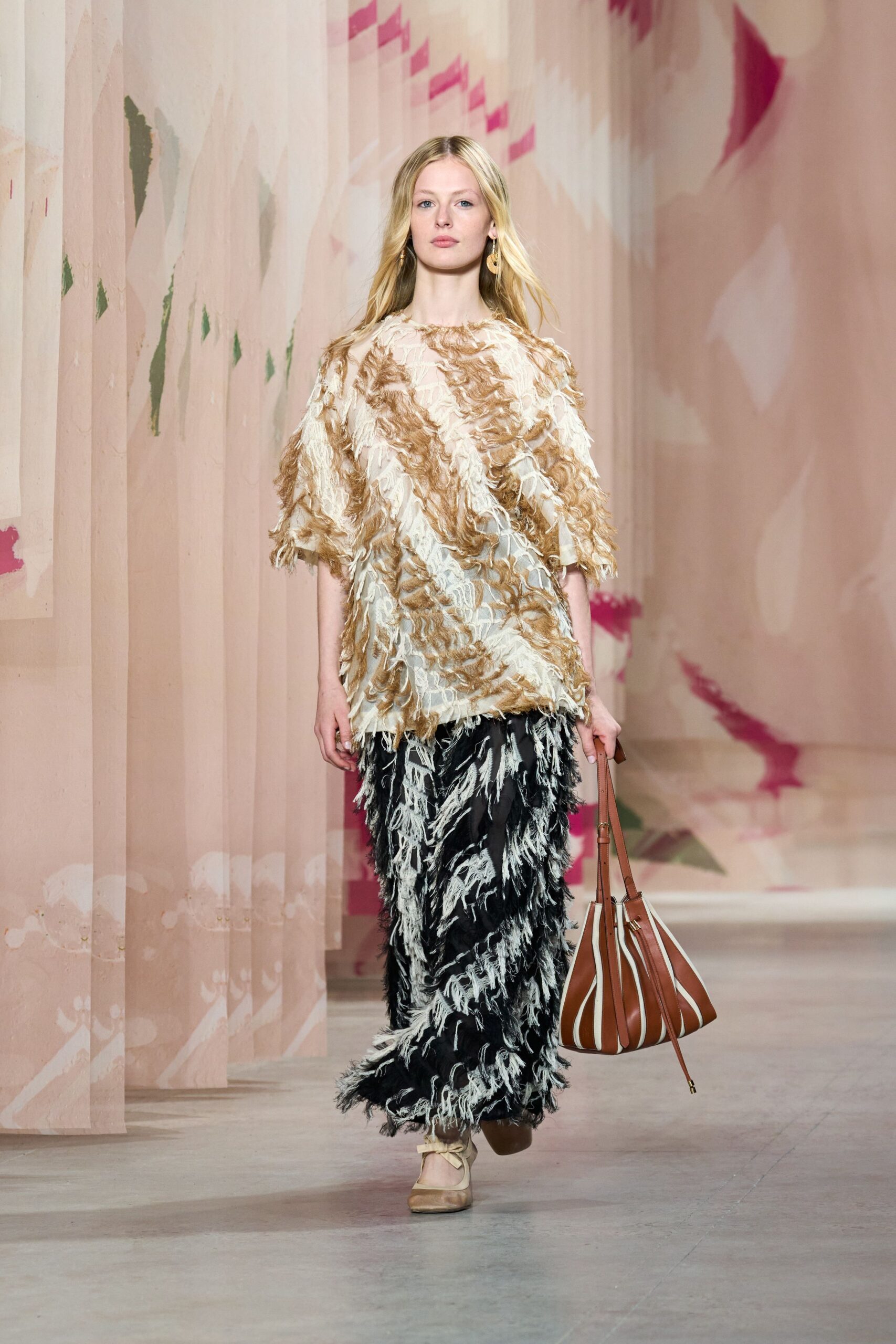 beige fringed top with black pants