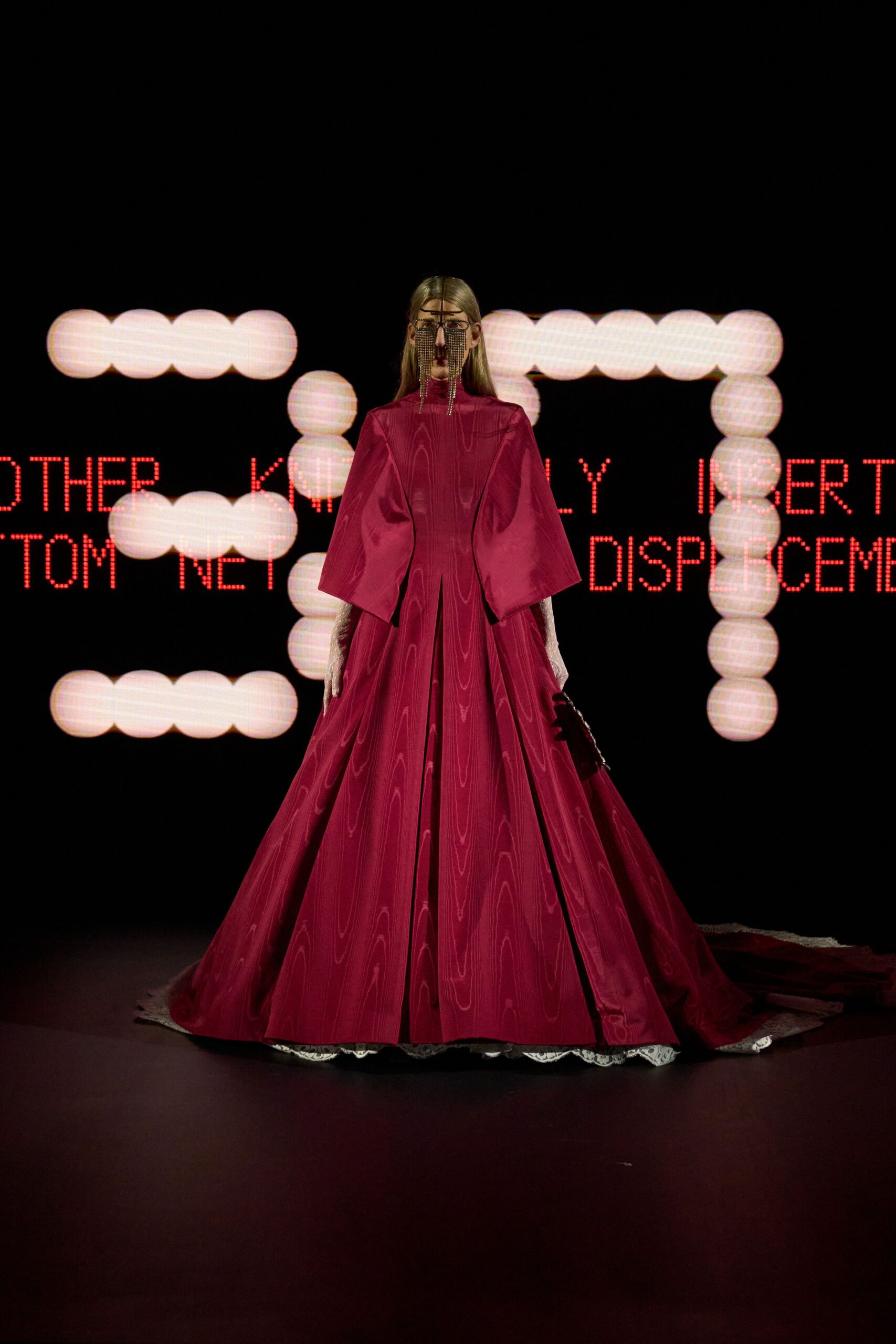 red silk long-sleeve high-neck fitted pleated flowing gown