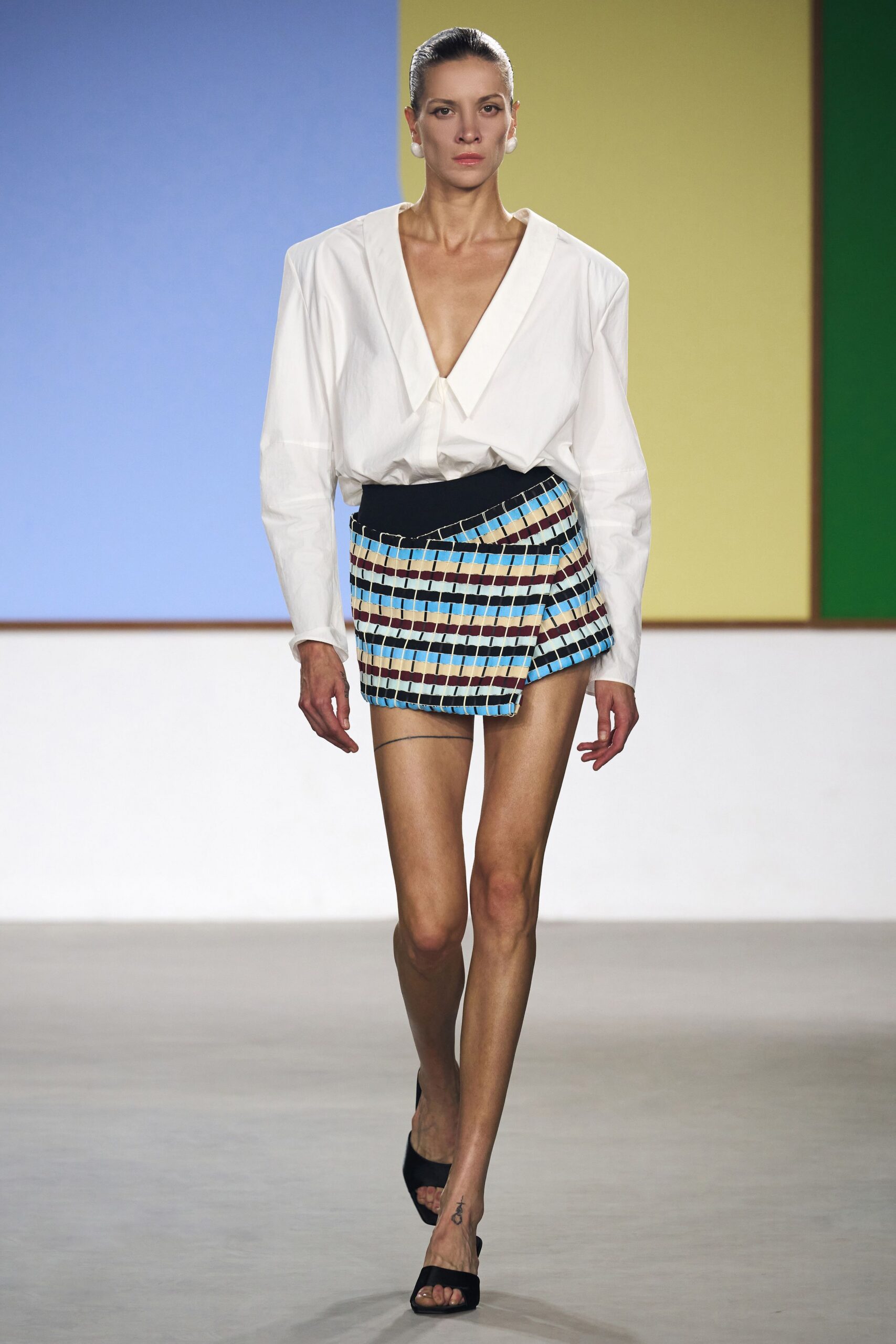 white relaxed shirt with mini skirt
