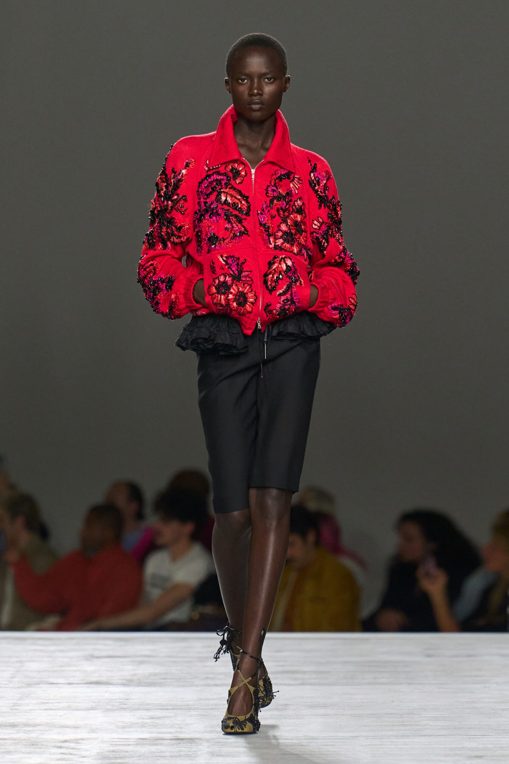 red embroidered jacket with black shorts