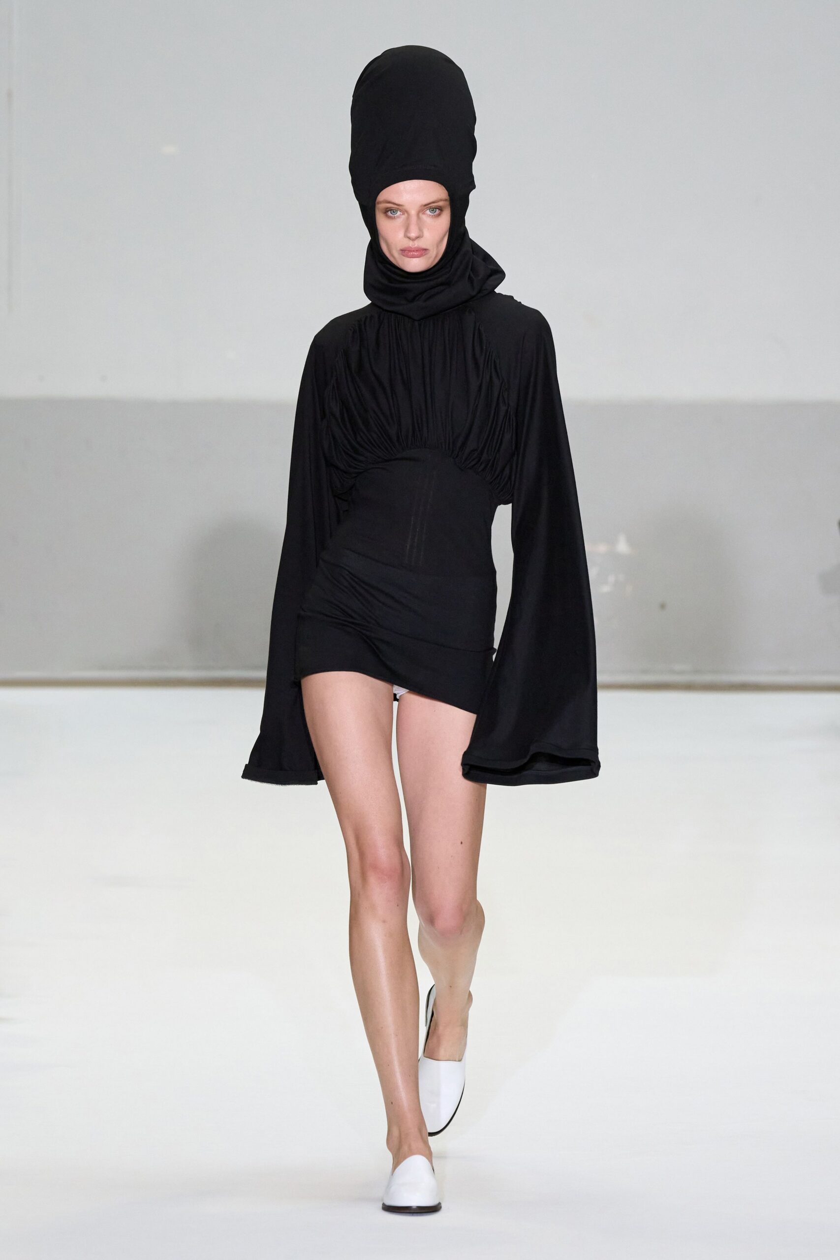 black fitted mini dress with white shoes