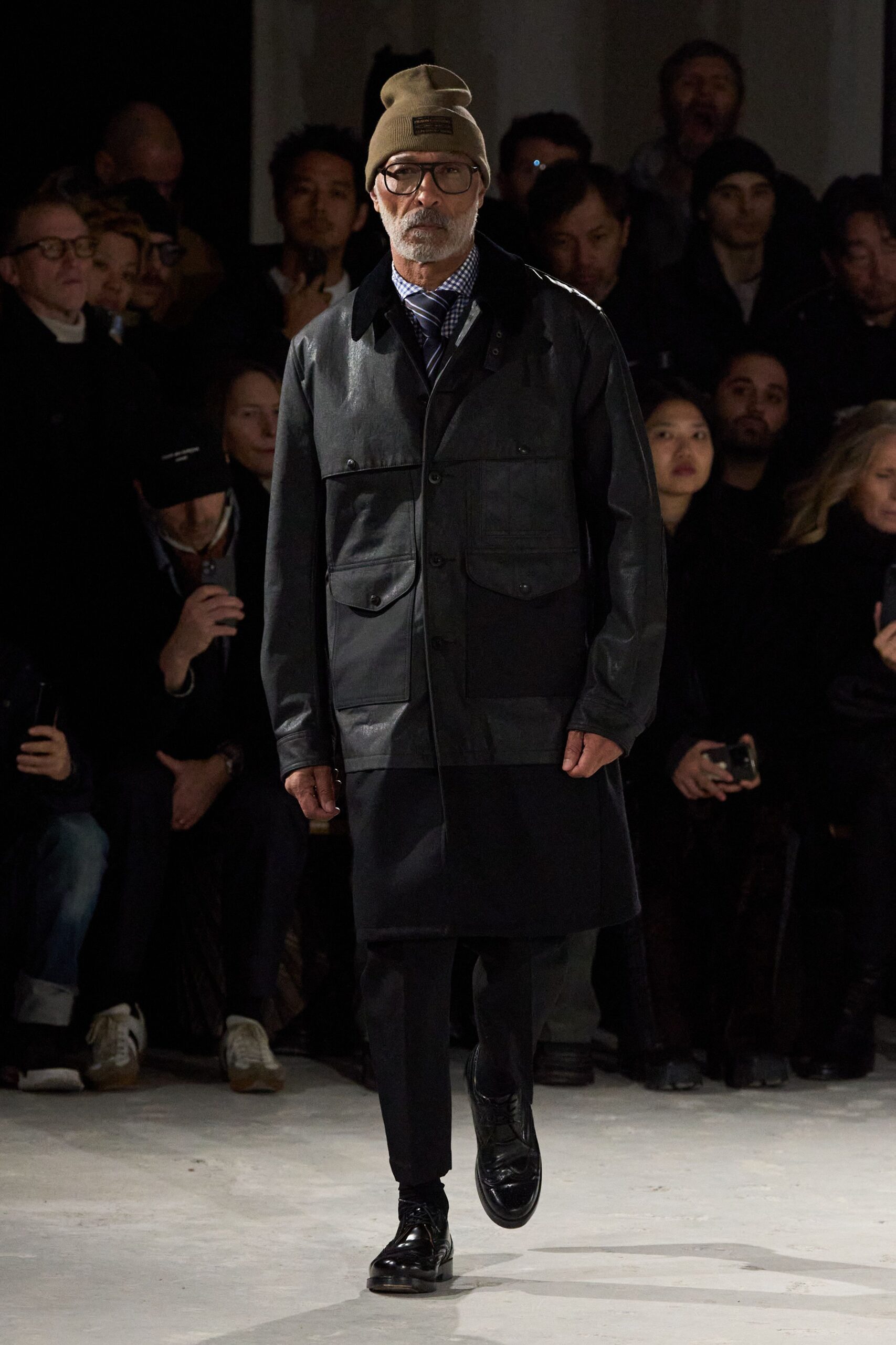 black leather coat with beige hat