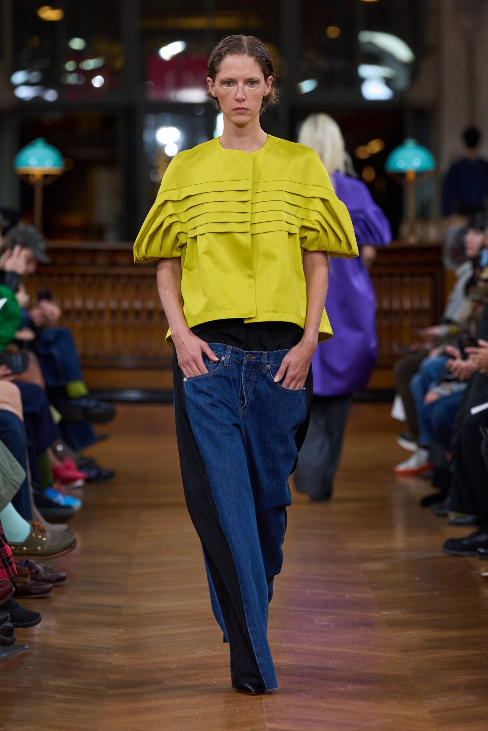 yellow pleated top with blue pants