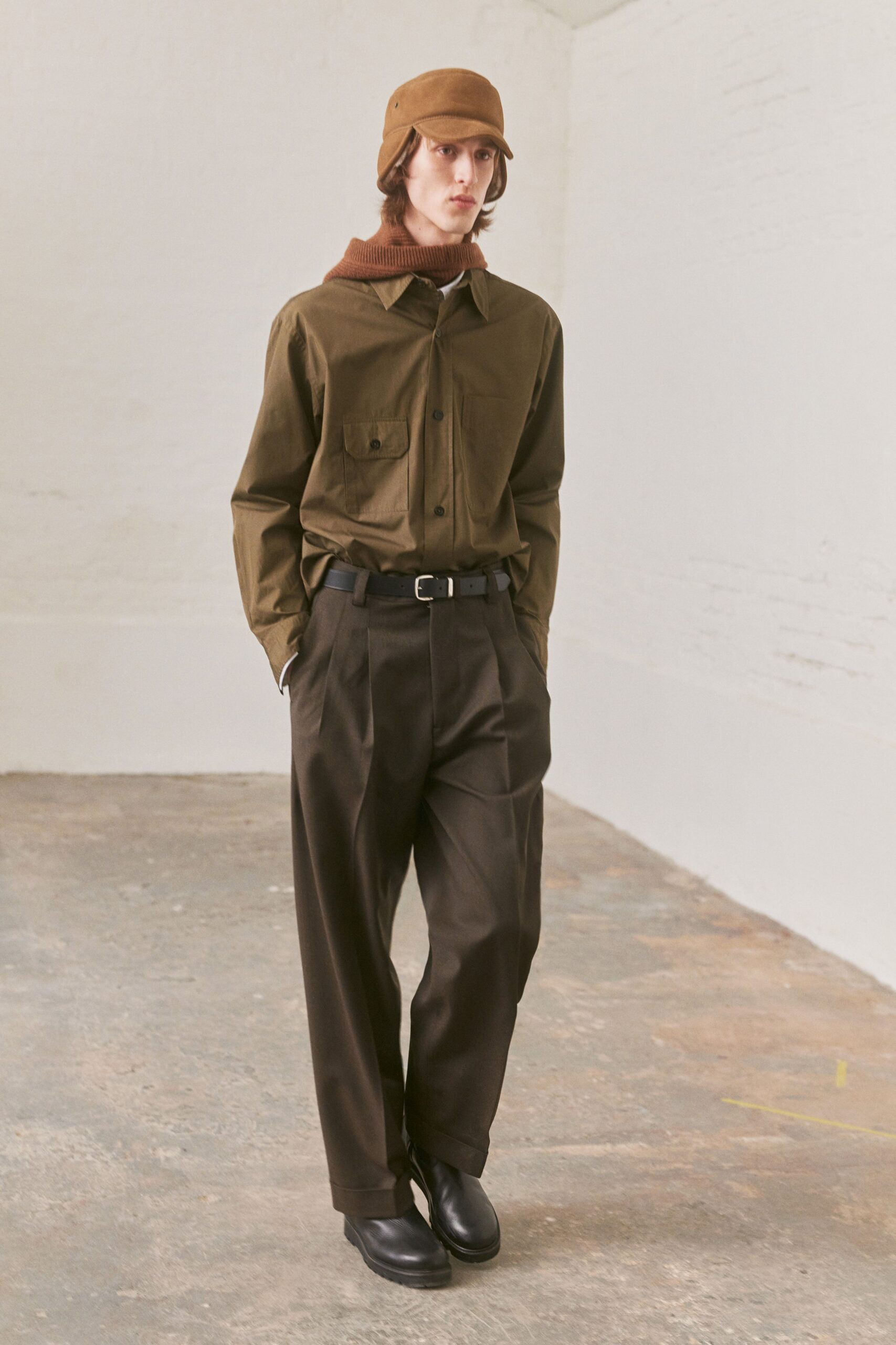 brown shirt and black pants