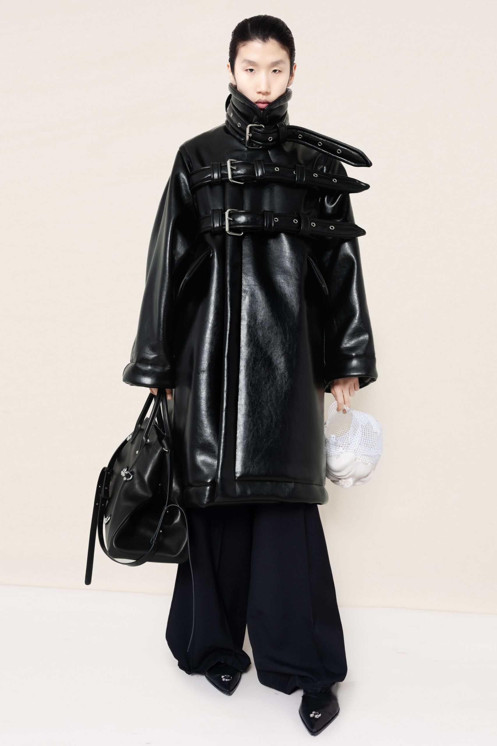 black leather long-sleeve collared oversized zippered buttoned coat