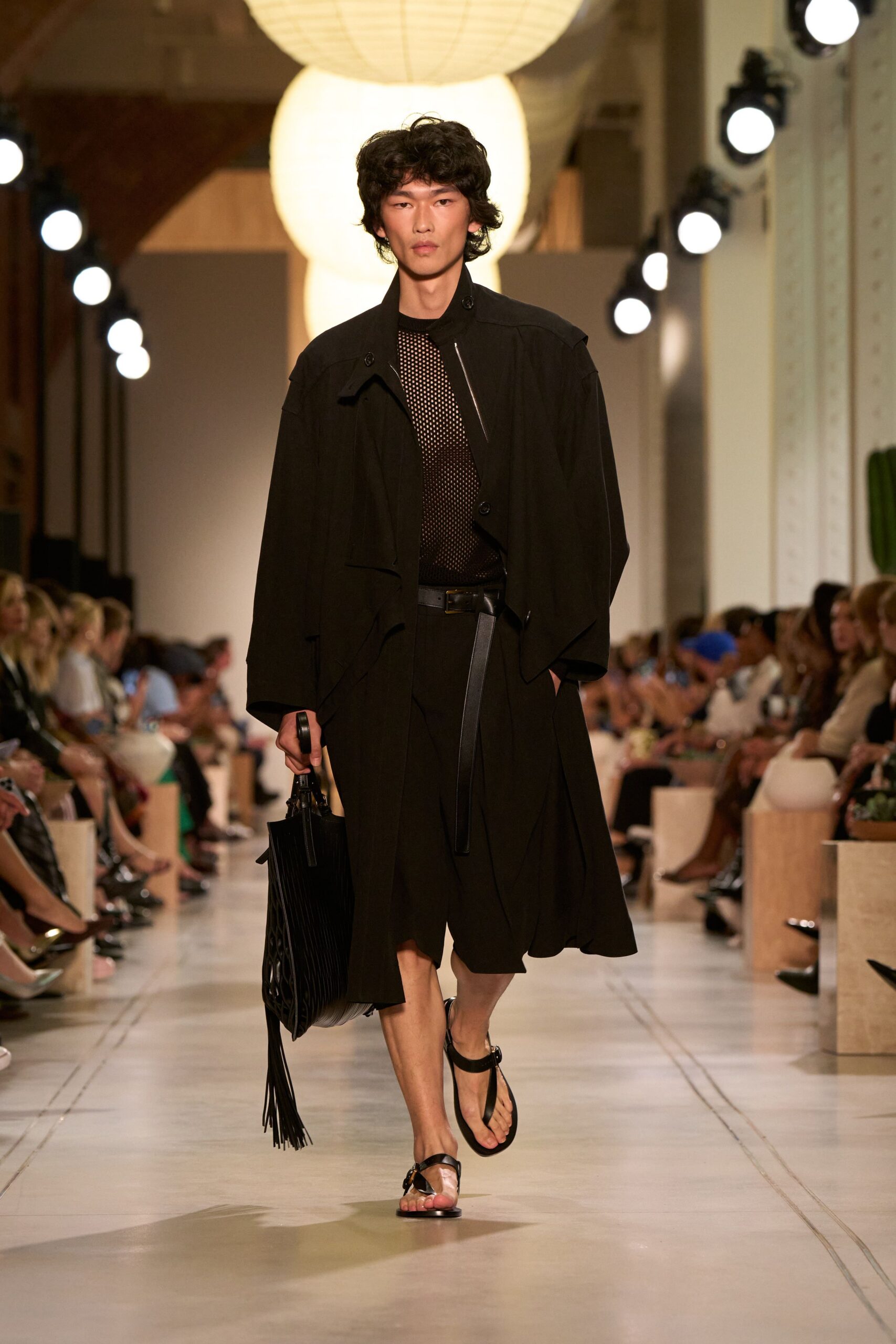 black relaxed coat with pleated skirt