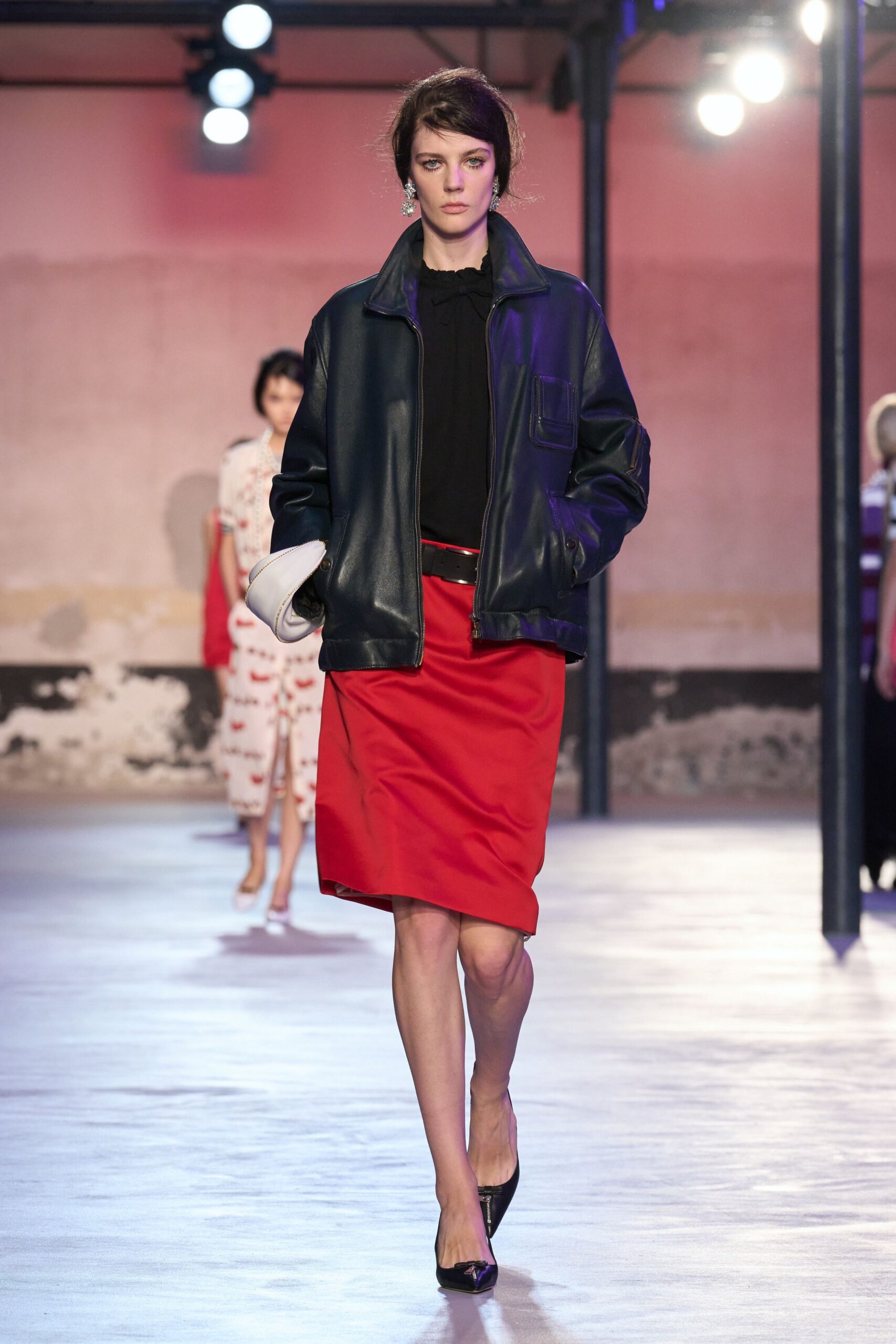 black leather oversized jacket and red fitted skirt