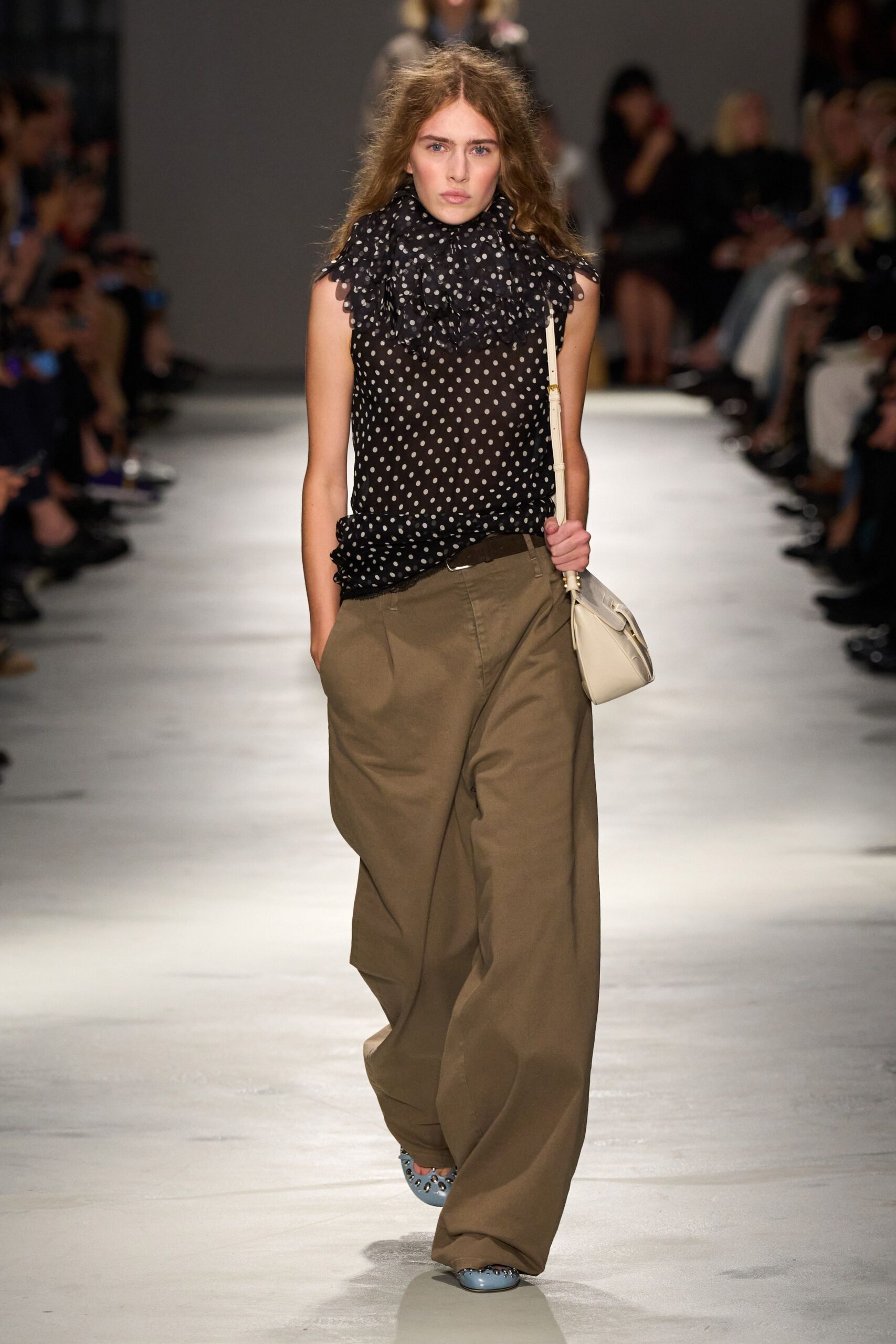 black polka-dot top with beige wide-leg pants