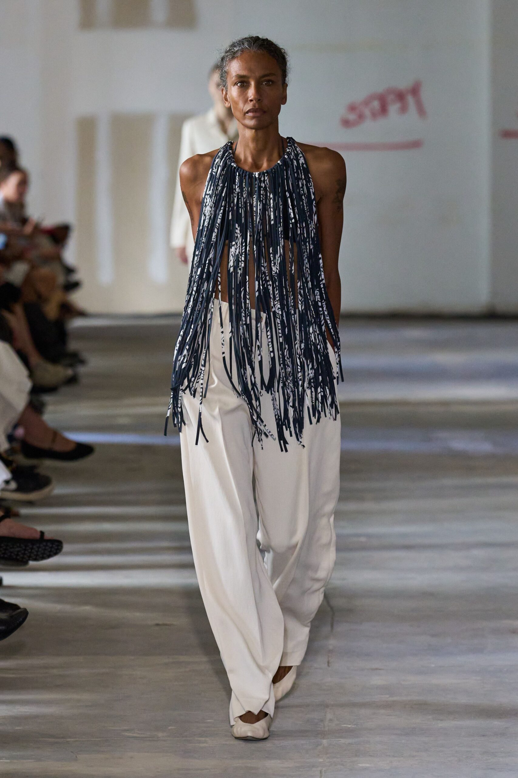 blue fringed top with white pants