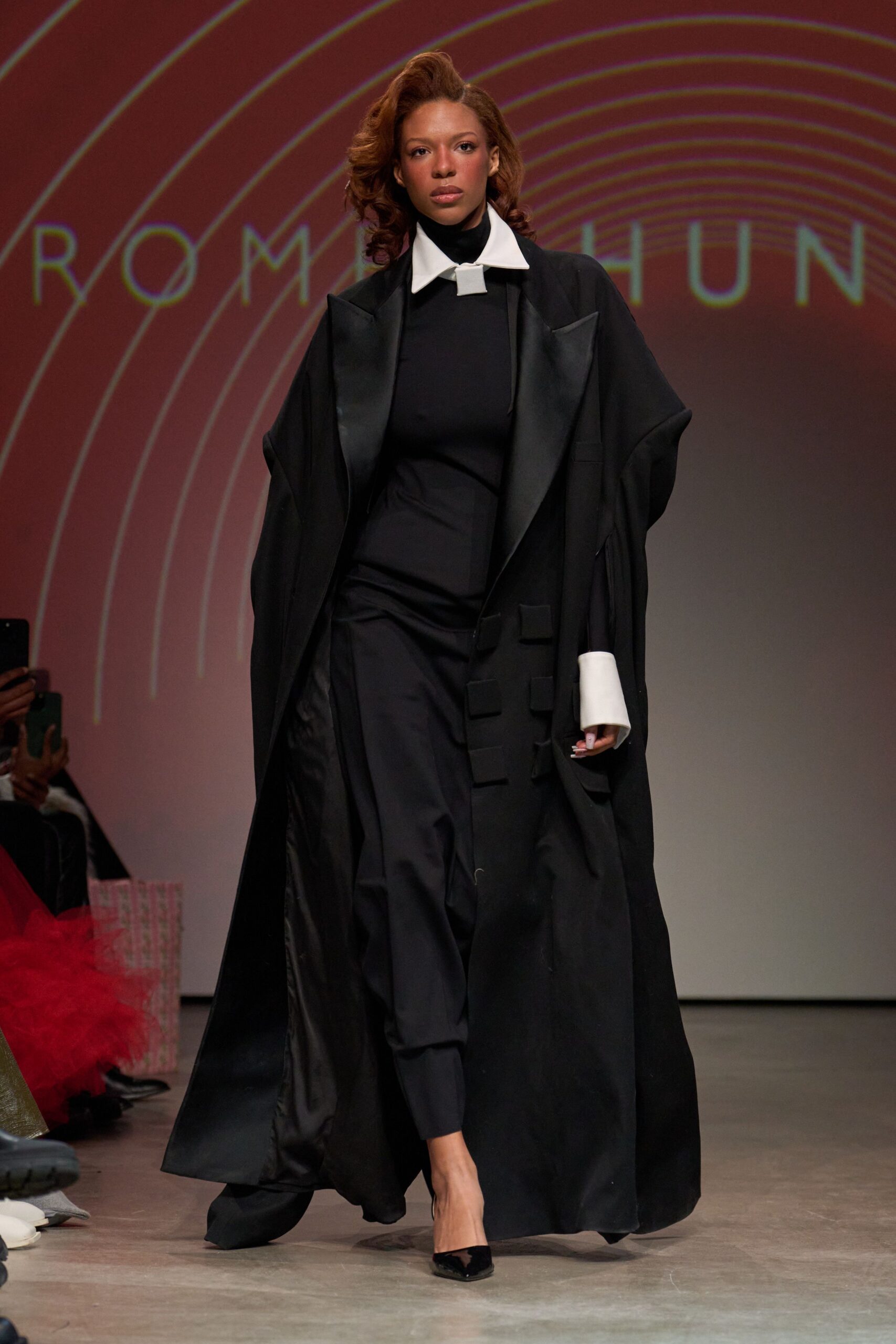 black coat over black jumpsuit