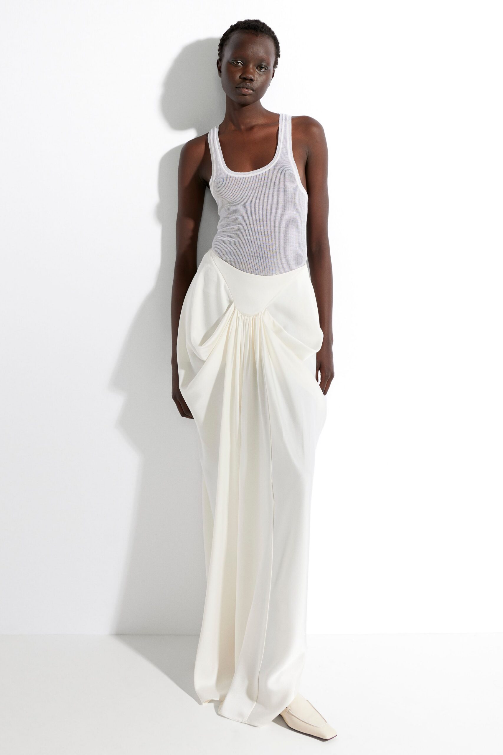 gray tank-top and white pleated dress