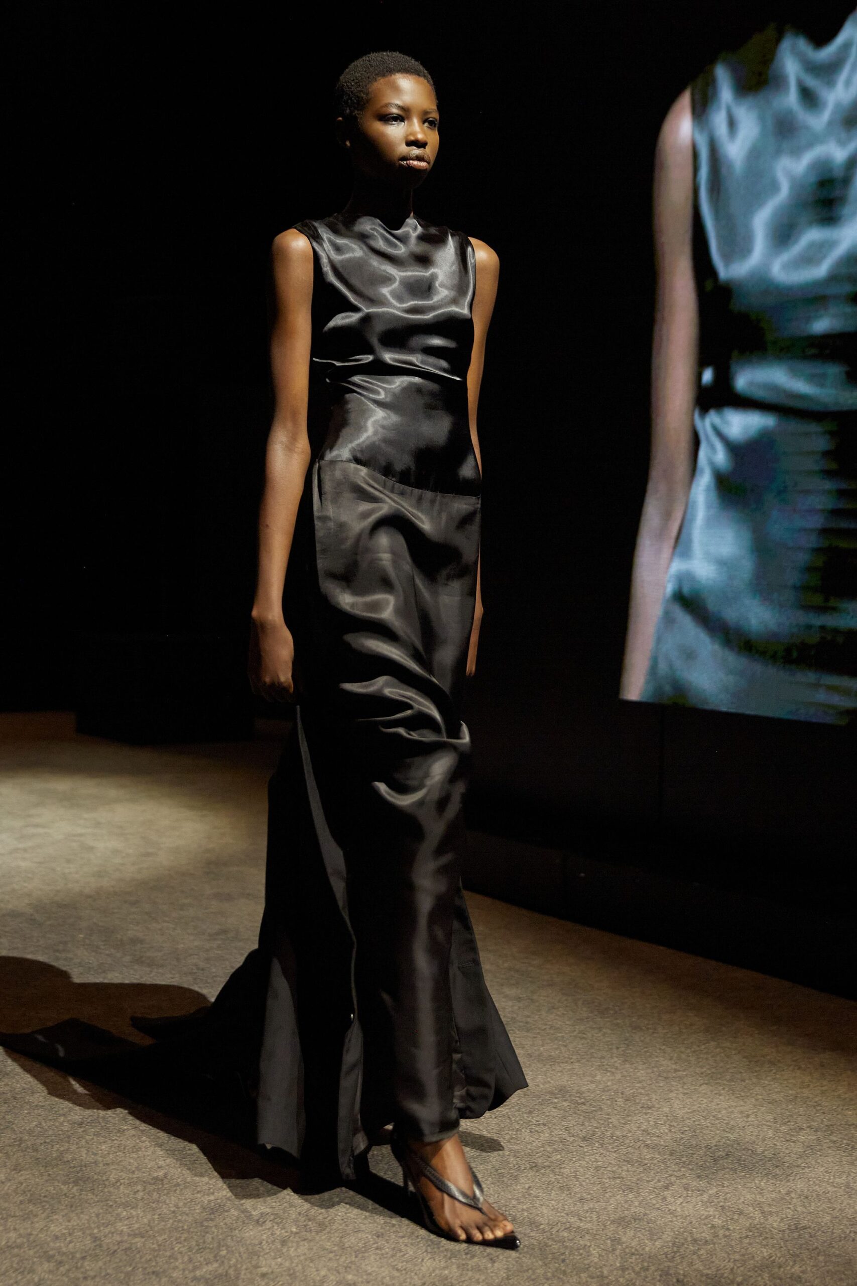 black silk fitted gown with strappy shoes