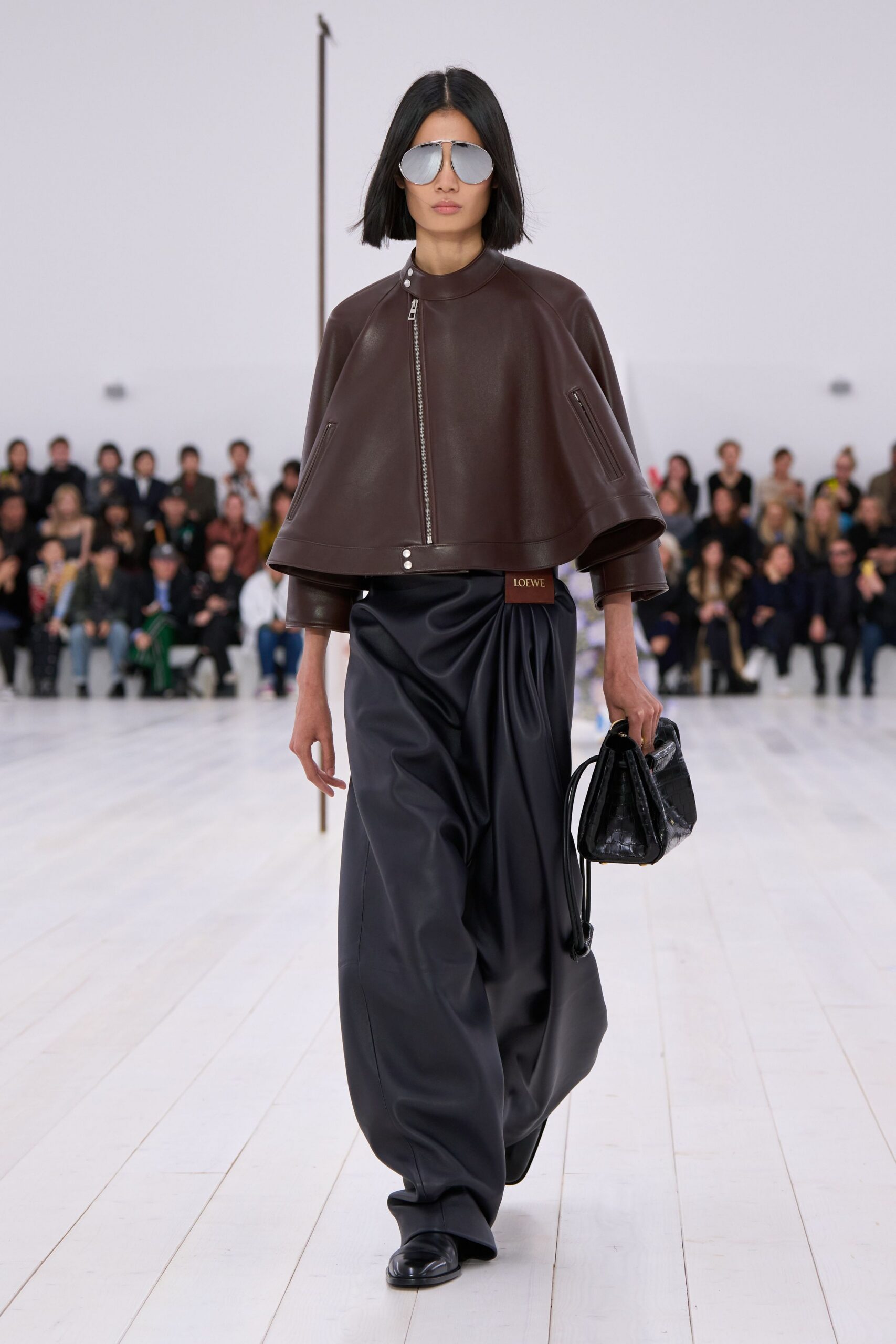 brown leather jacket with black pants