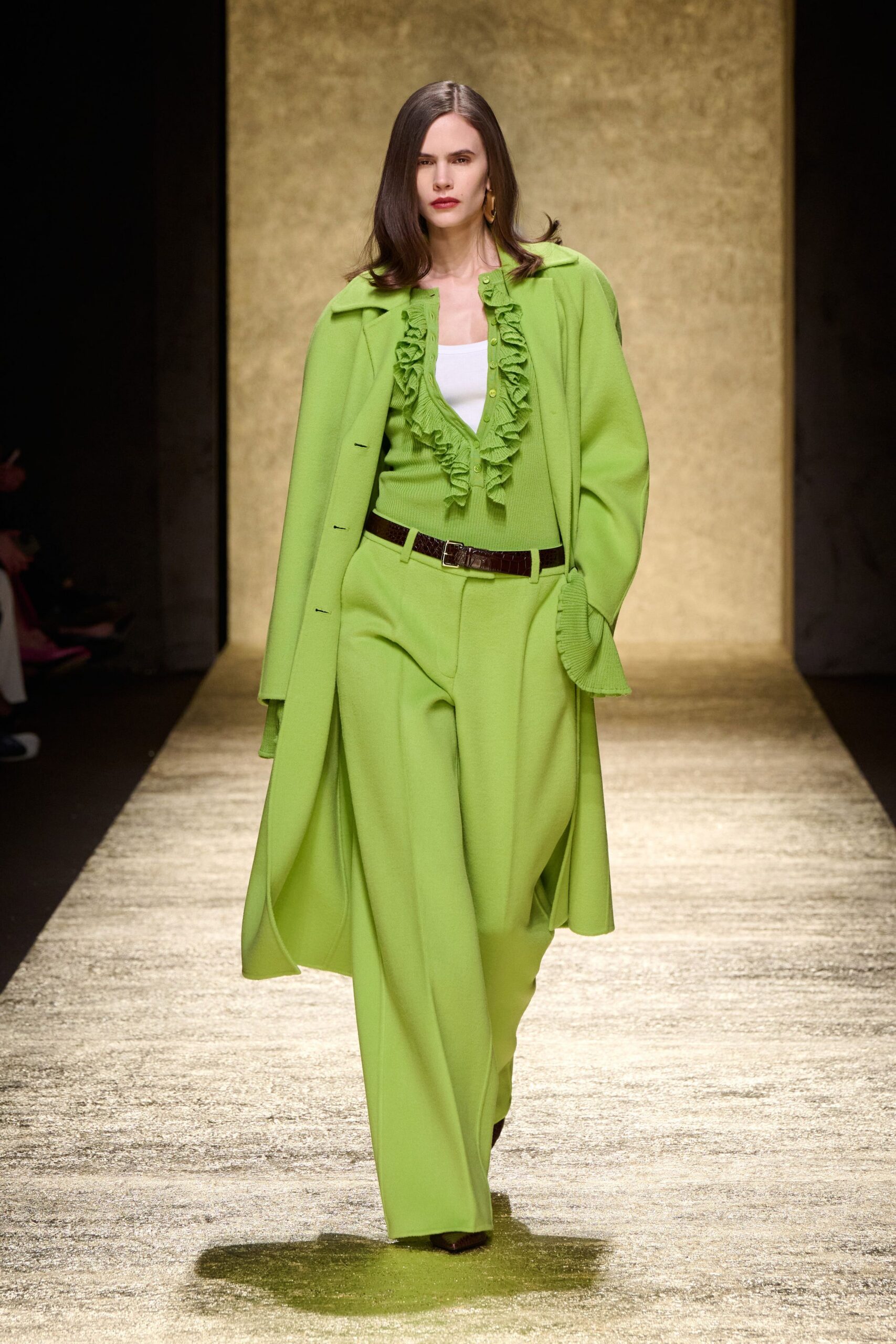 green coat and blouse with pants