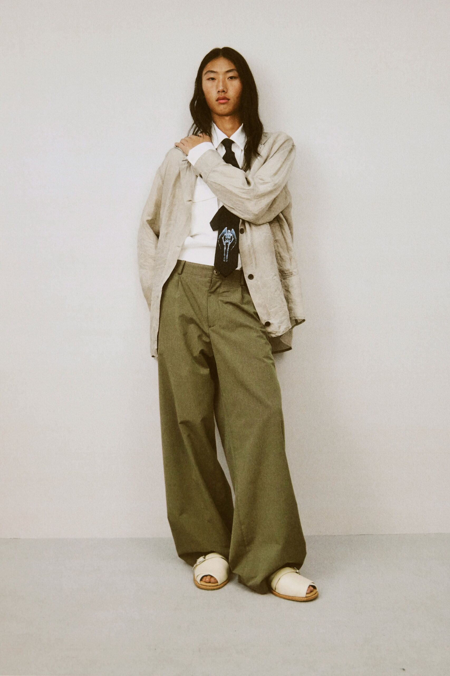 beige jacket white shirt green pants