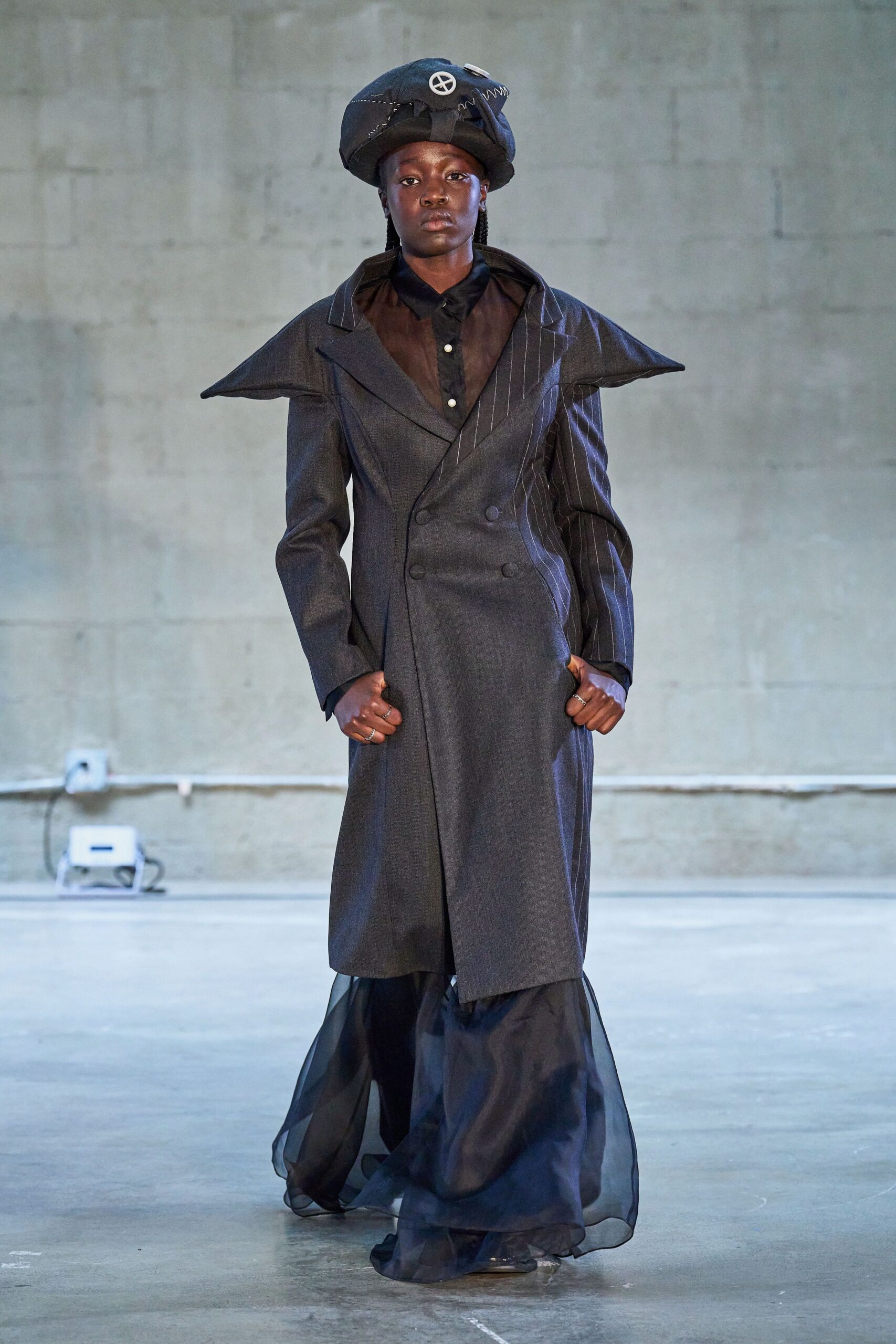 black wool long-sleeve collared structured pleated layered coat