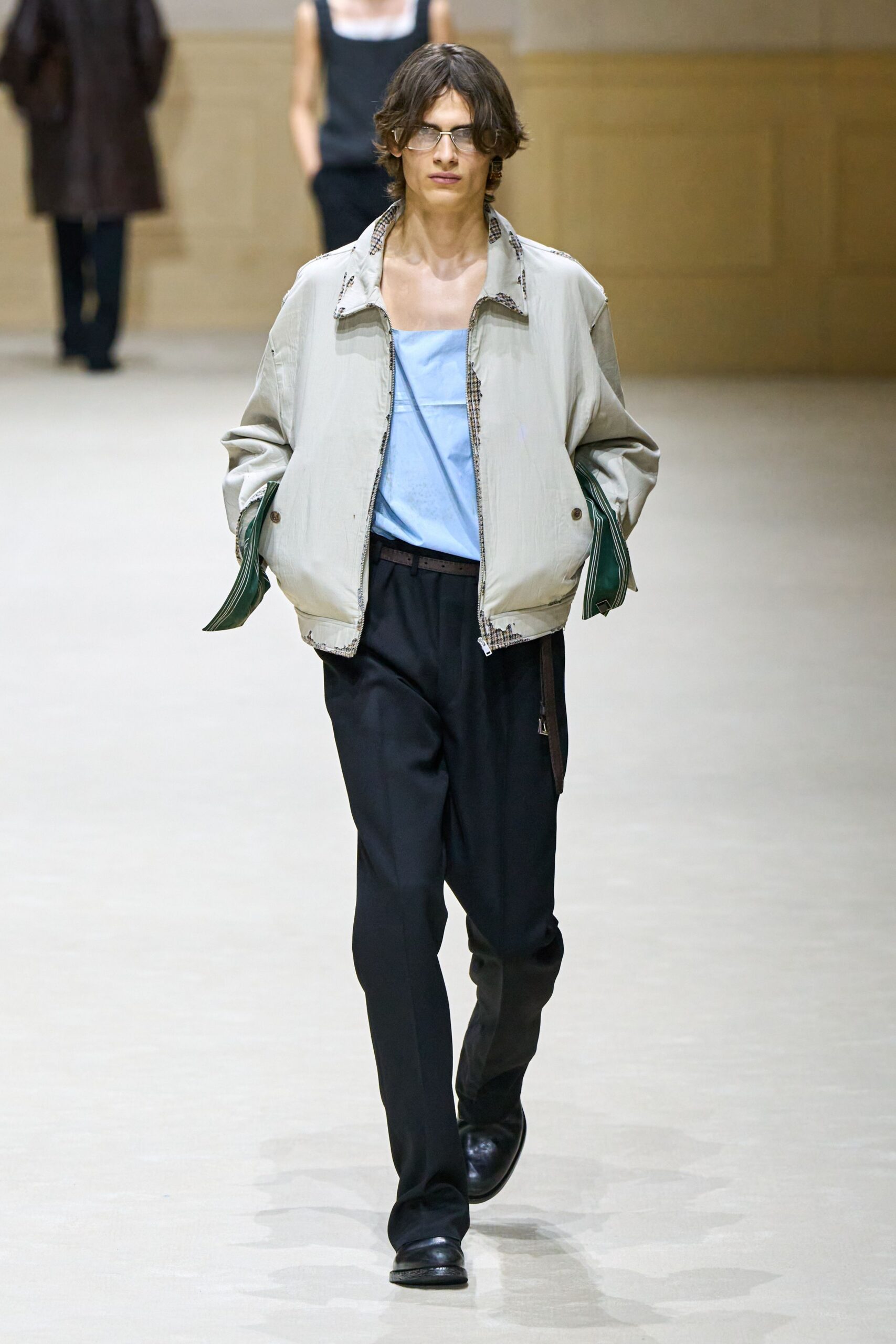 beige jacket blue top black pants