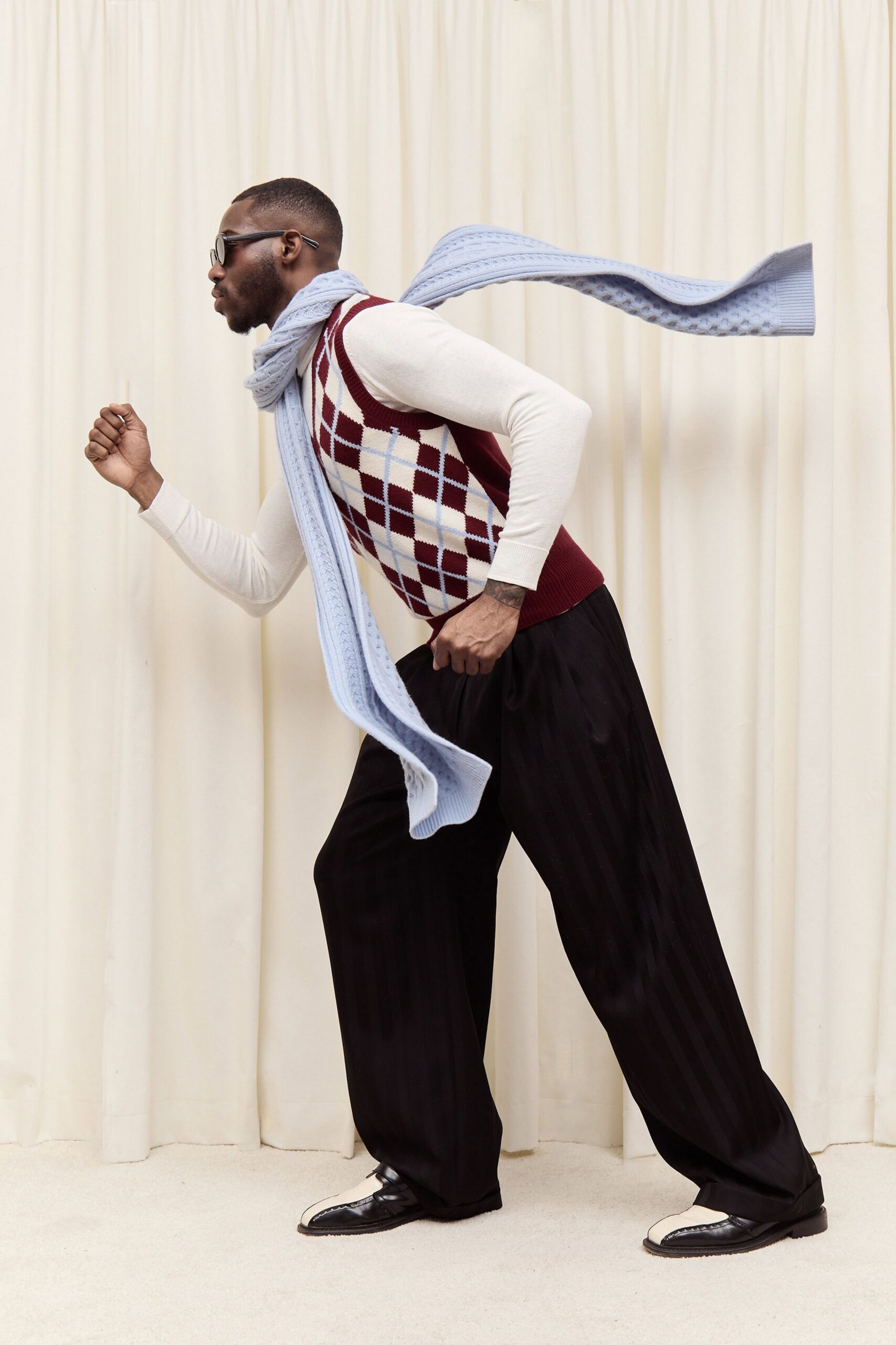 red argyle sweater with relaxed pants
