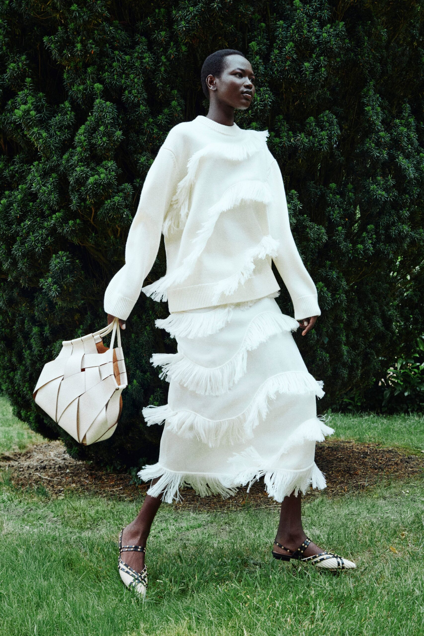 white fringed sweater and skirt