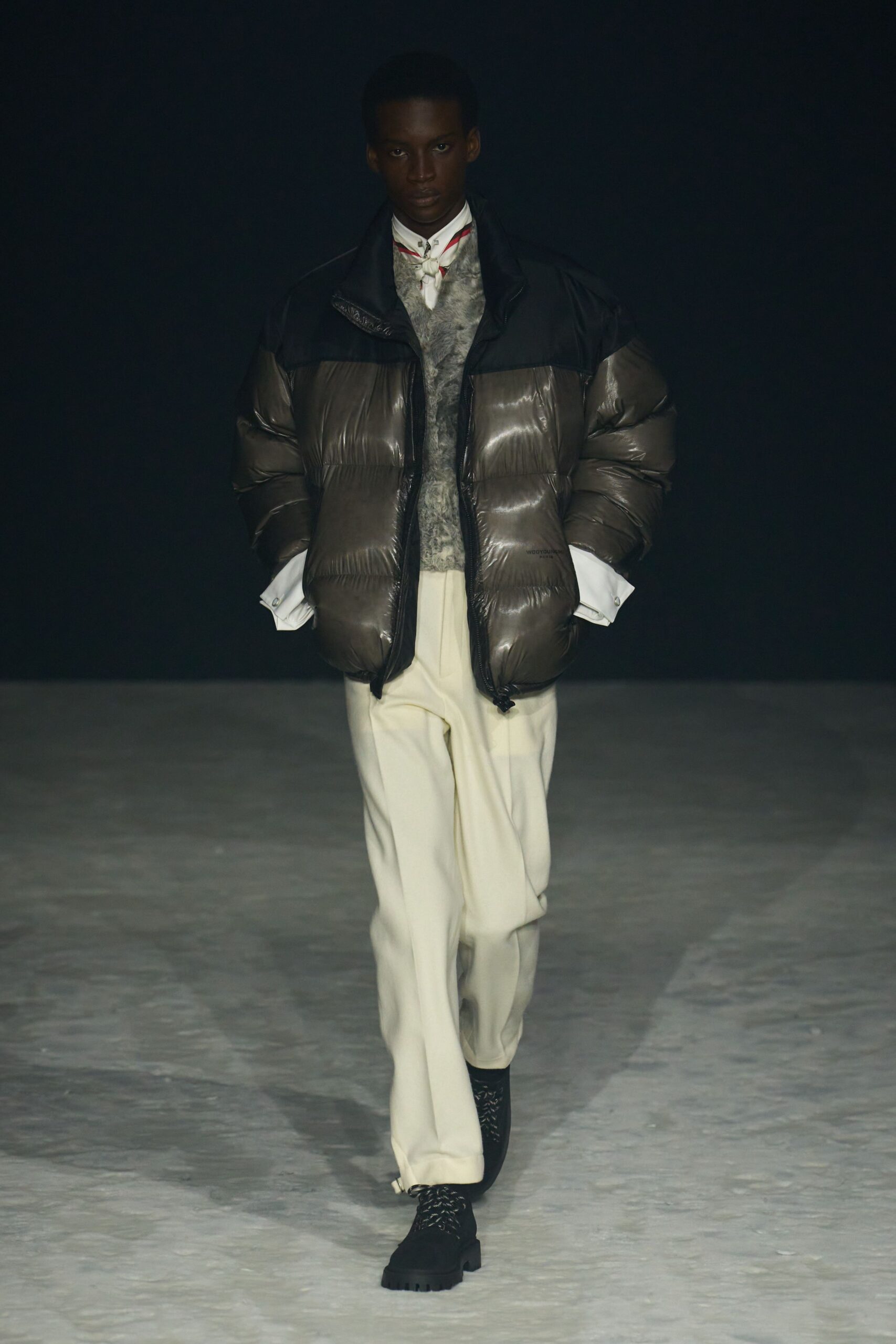 gray padded jacket with sweater and tailored pants