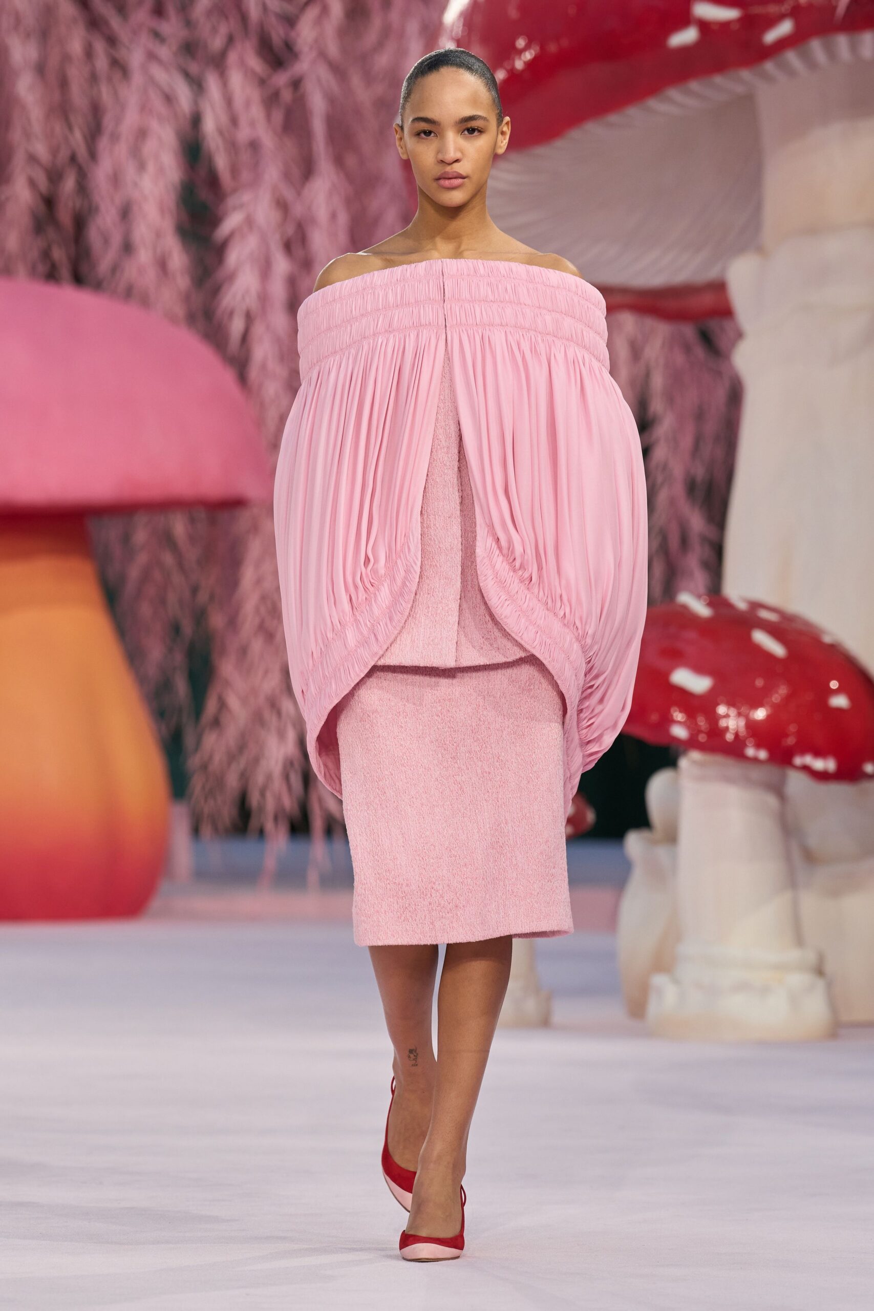 pink pleated off-shoulder dress with red shoes