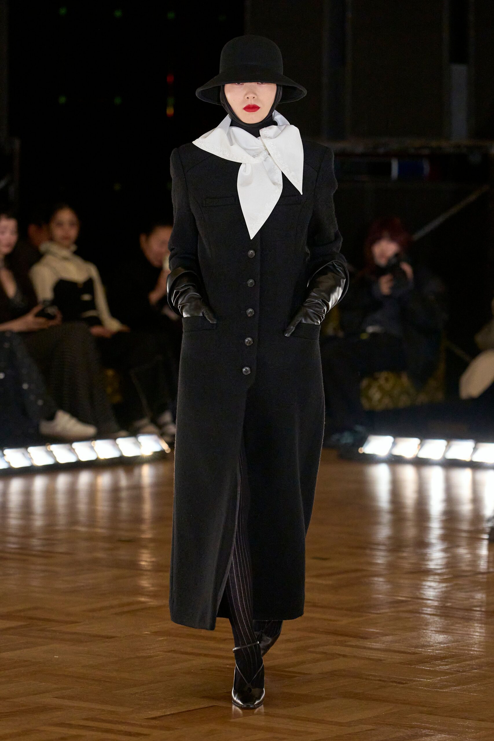 black wool fitted coat with white blouse