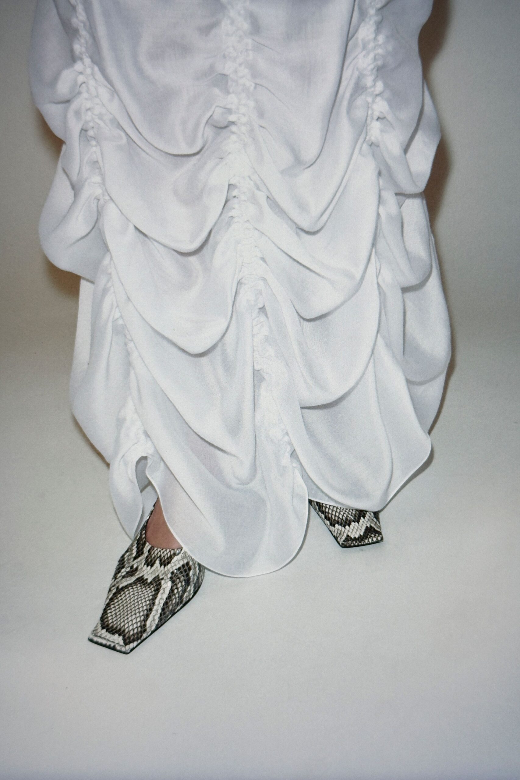 white ruched maxi dress with animal-print shoes