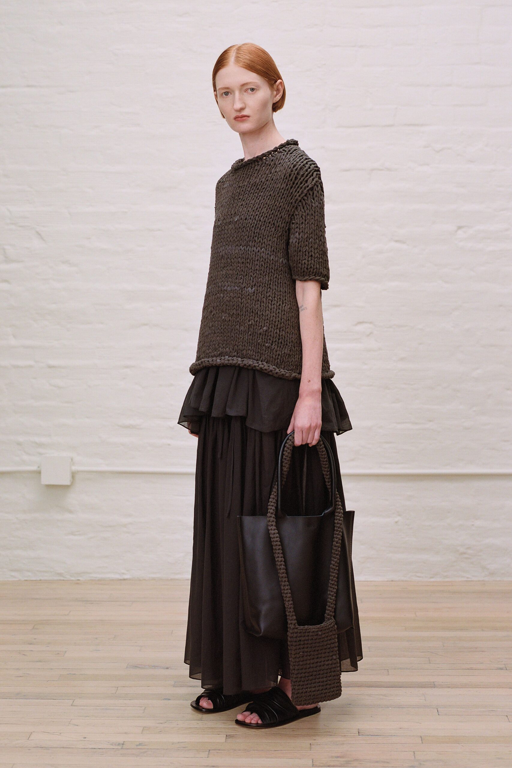 brown relaxed top with black skirt