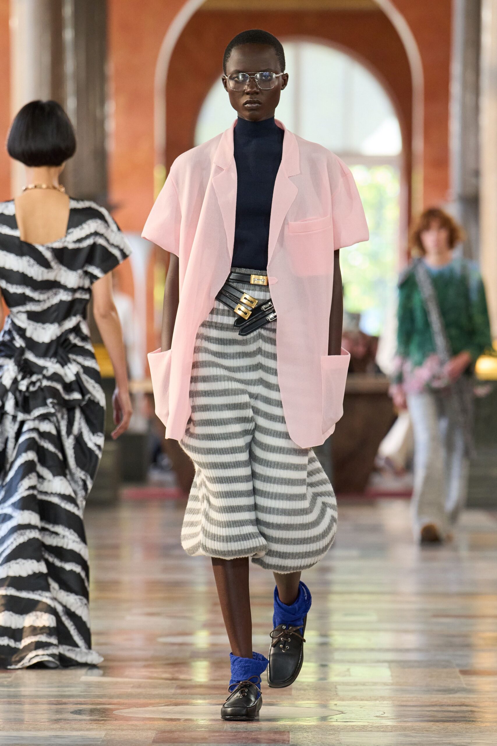 pink jacket blue top striped pants