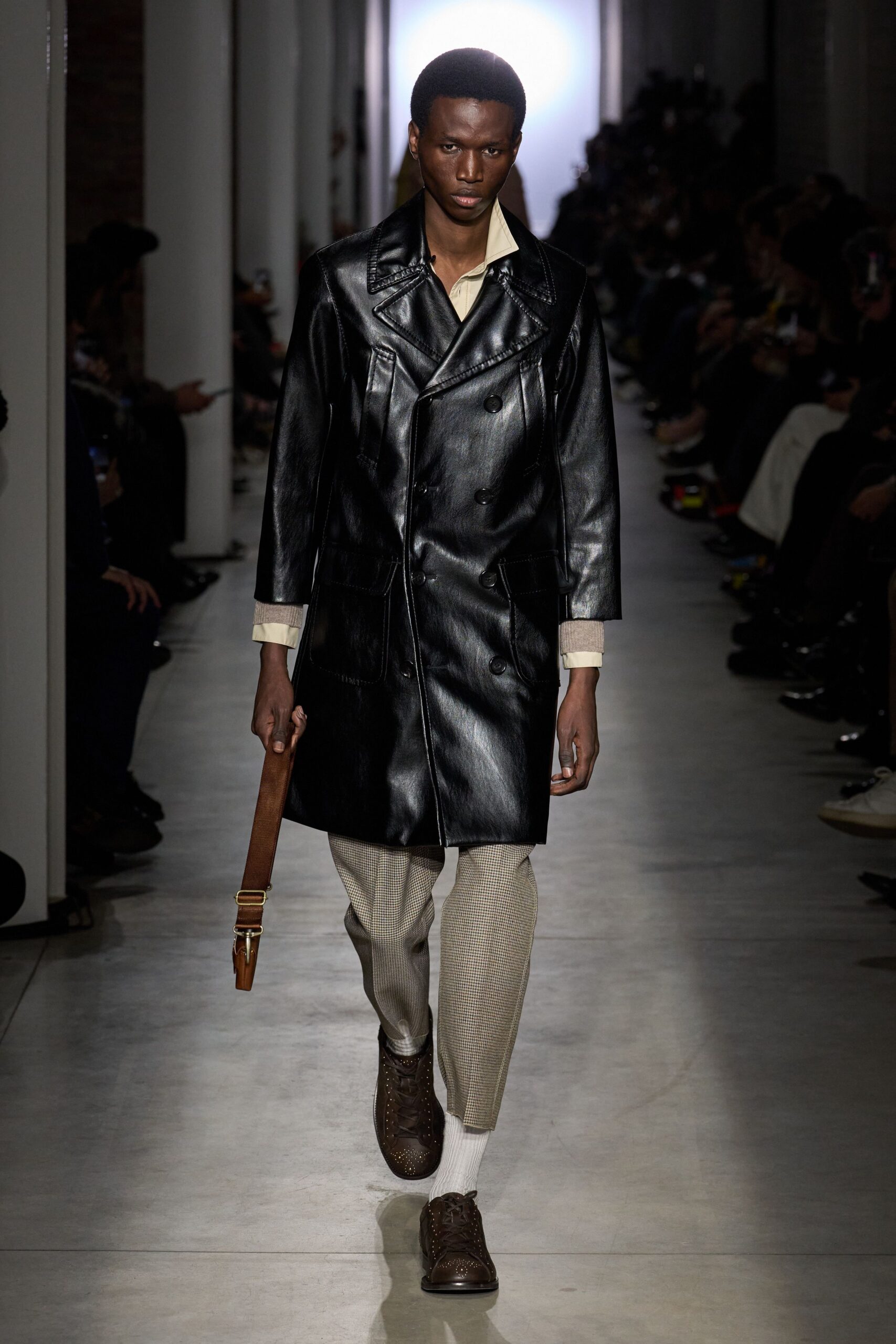black leather coat with beige pants