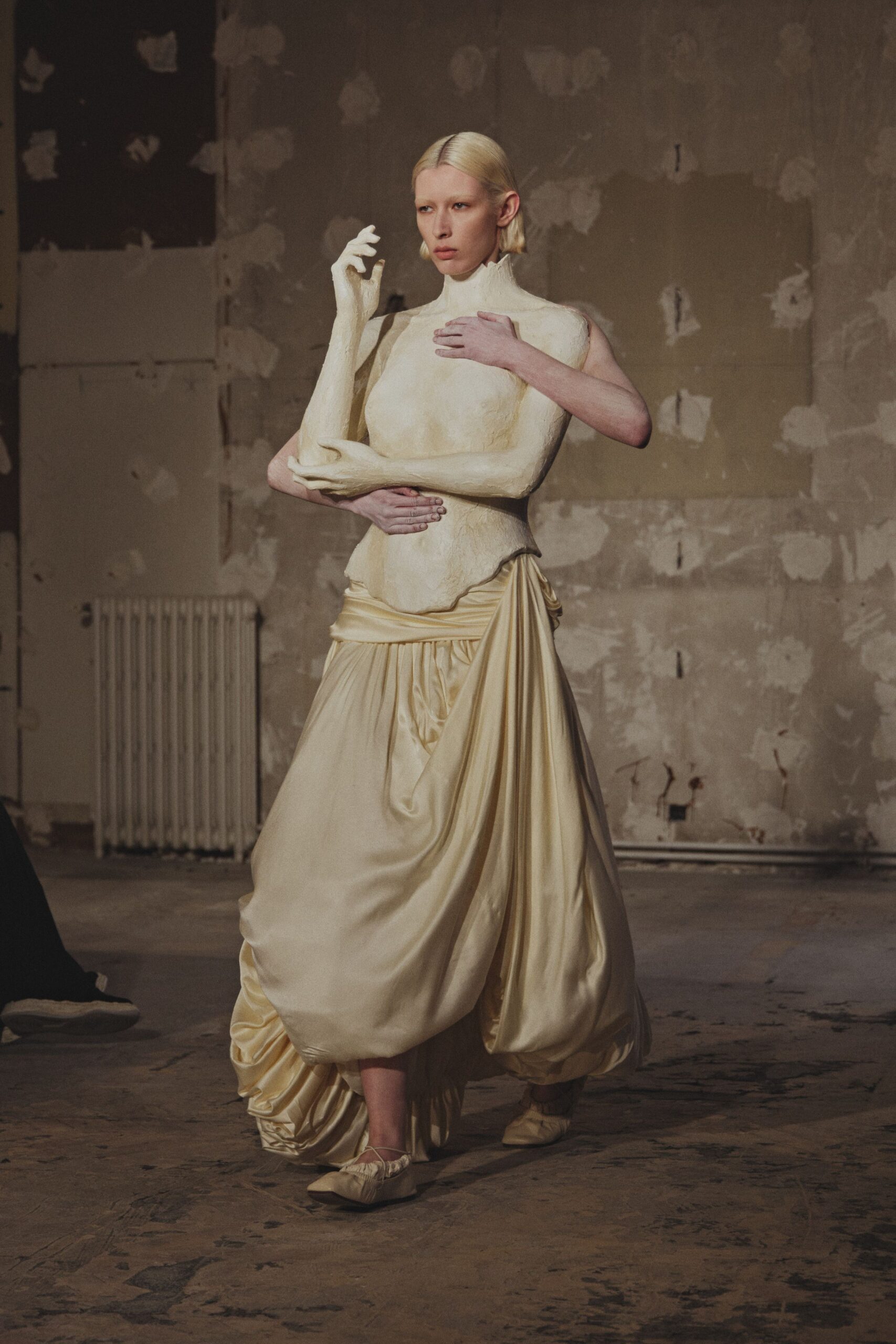 beige silk sleeveless high-neck fitted draped flowing gown