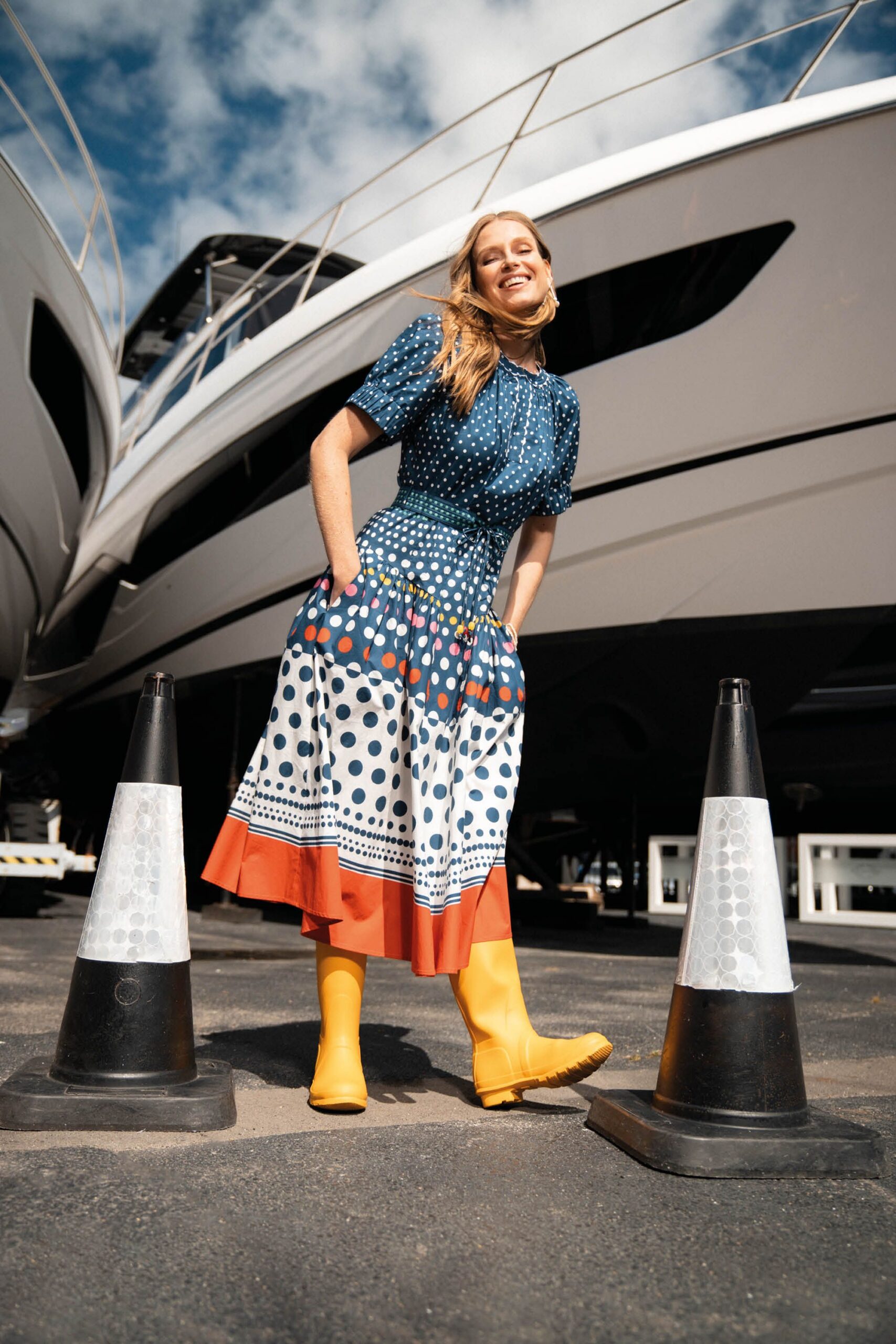 blue and white polka-dot midi dress with yellow boots