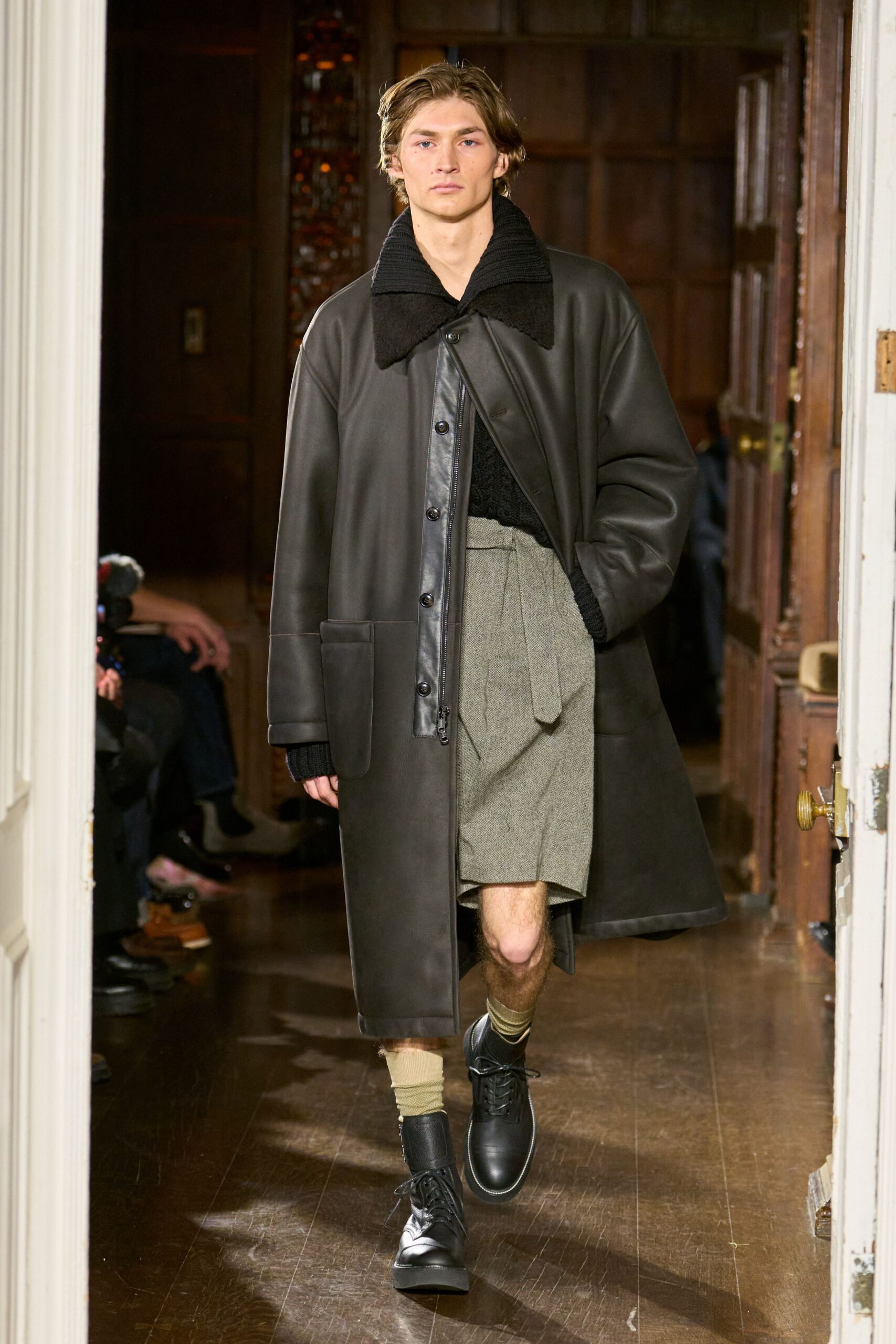 black leather coat gray pleated skirt