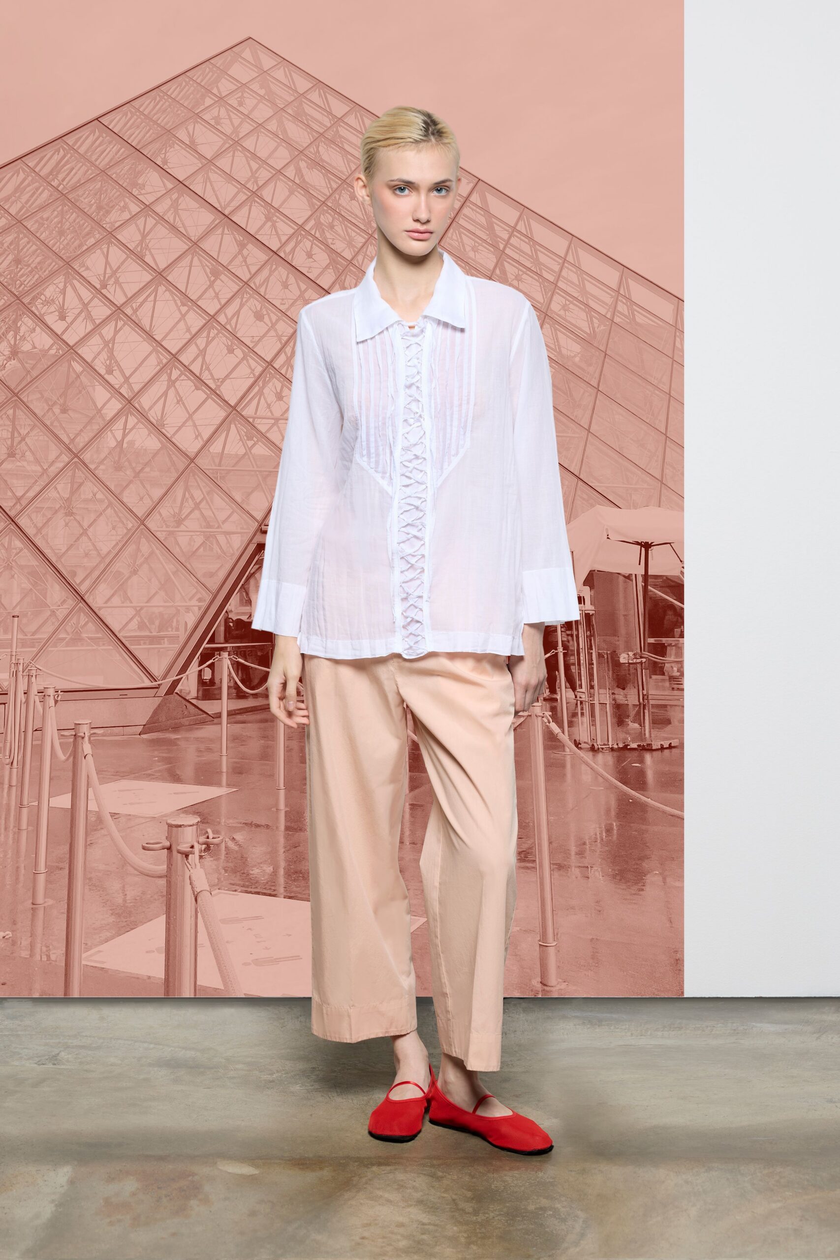 white relaxed shirt beige wide-leg pants red shoes