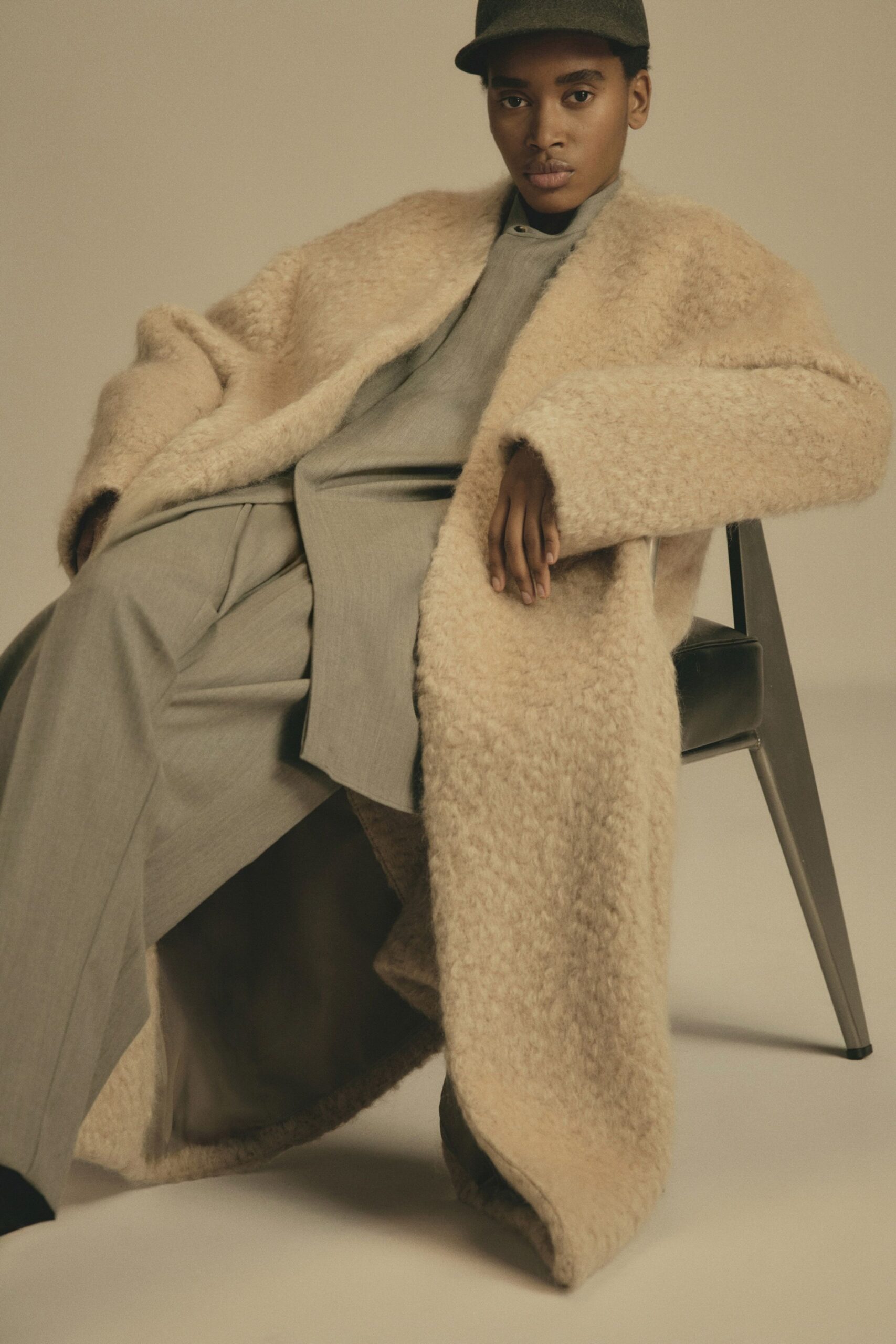 beige faux-fur coat with gray pants