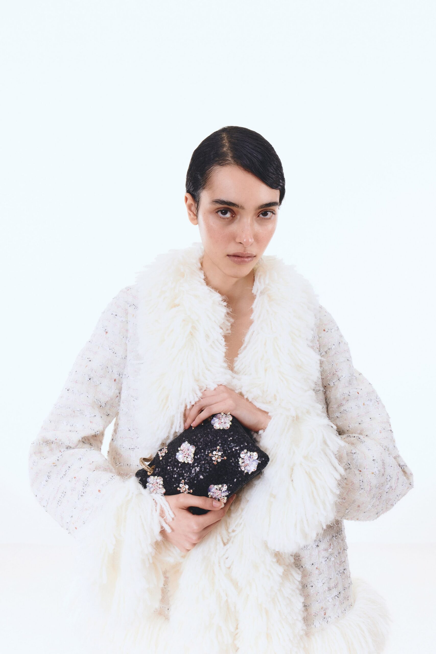 white fur jacket with beaded bag