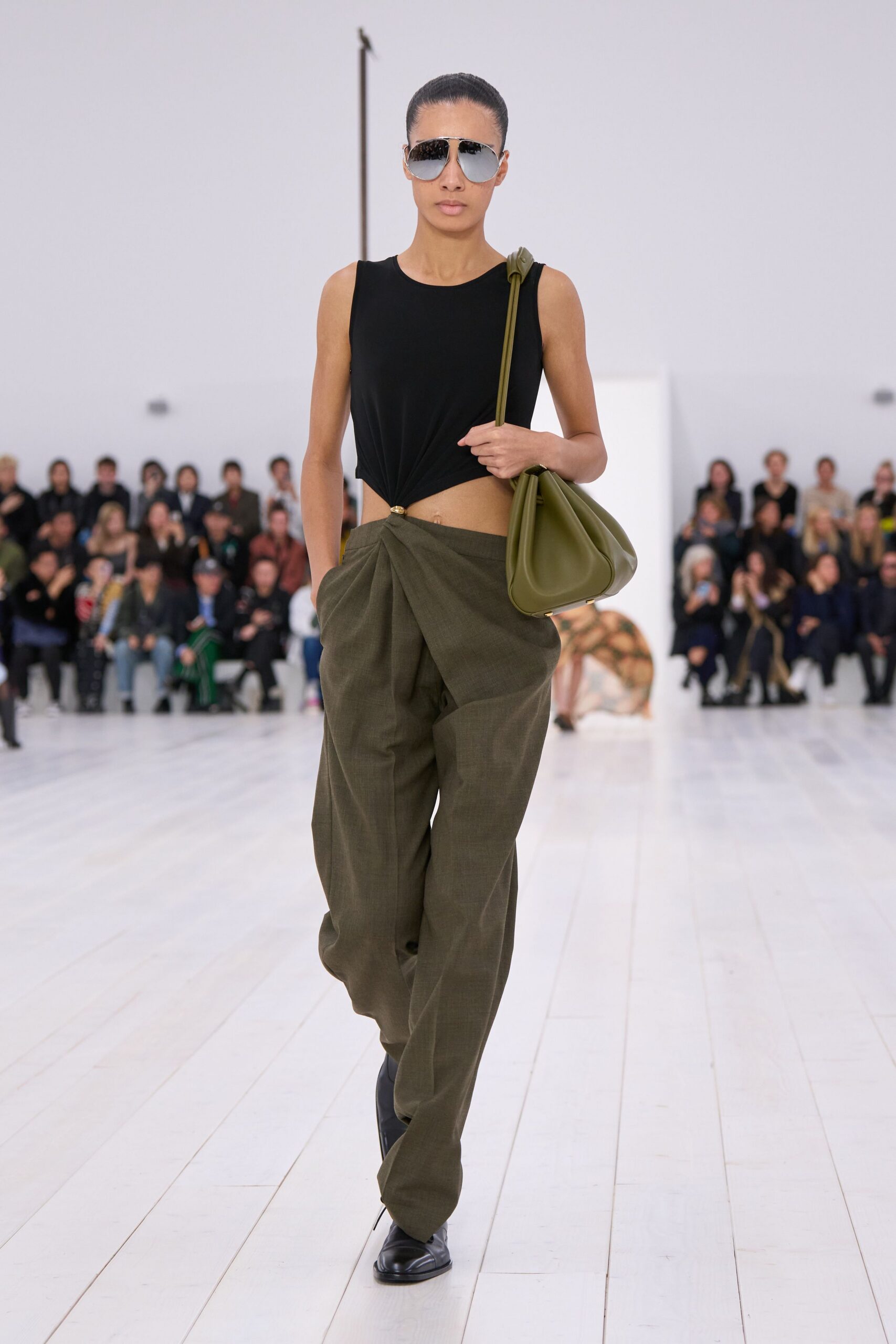 black fitted top with green pants