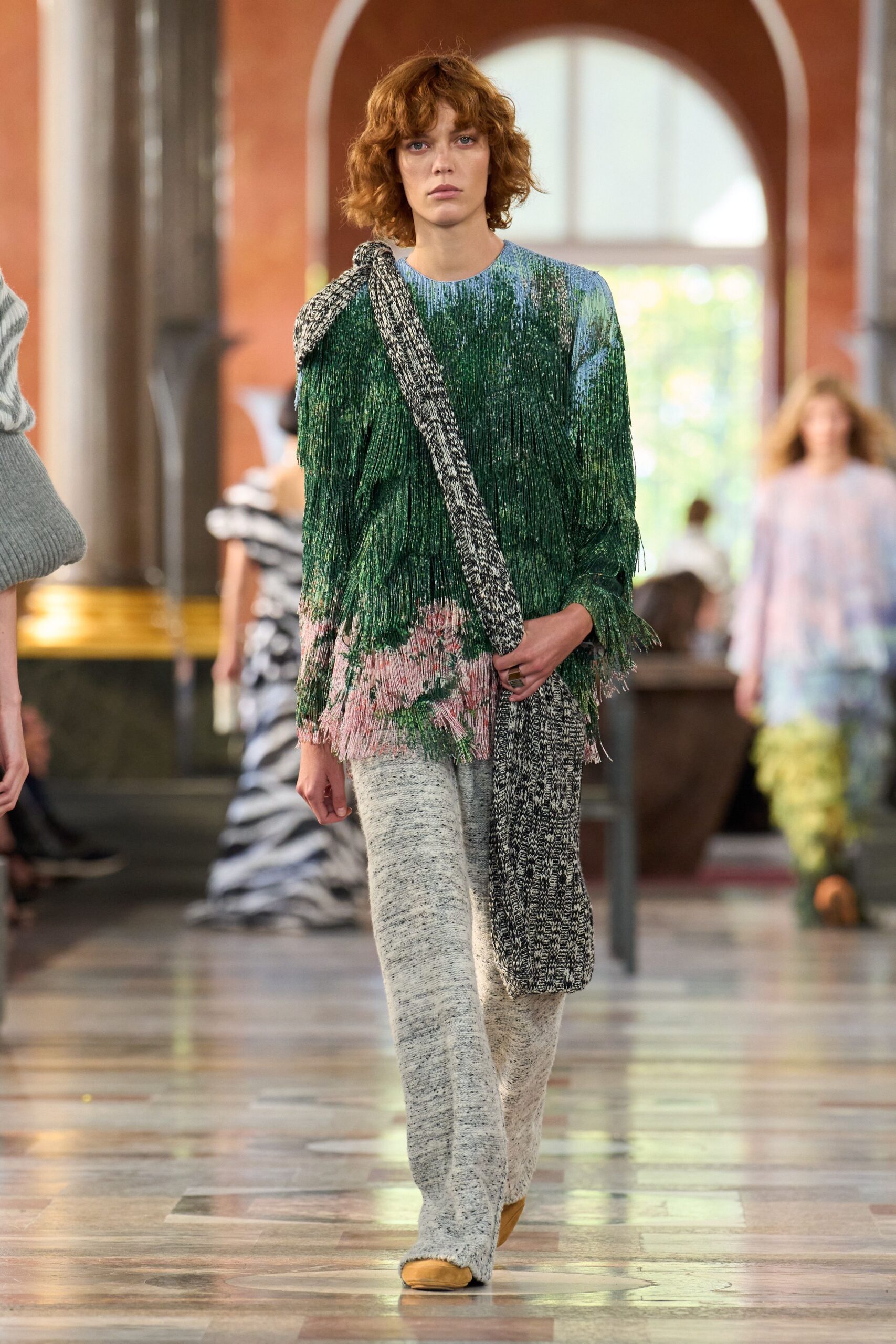fringed green top with gray pants